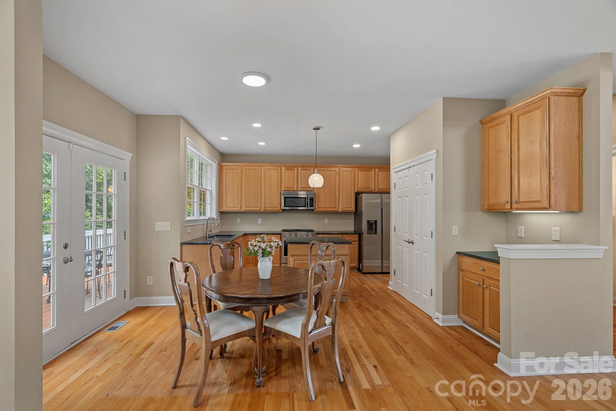View of kitchen and breakfast area featuring the spacious pantry and extra cabinet feature/maybe wetbar-coffee bar. - 9329 Uxbridge Lane, Huntersville