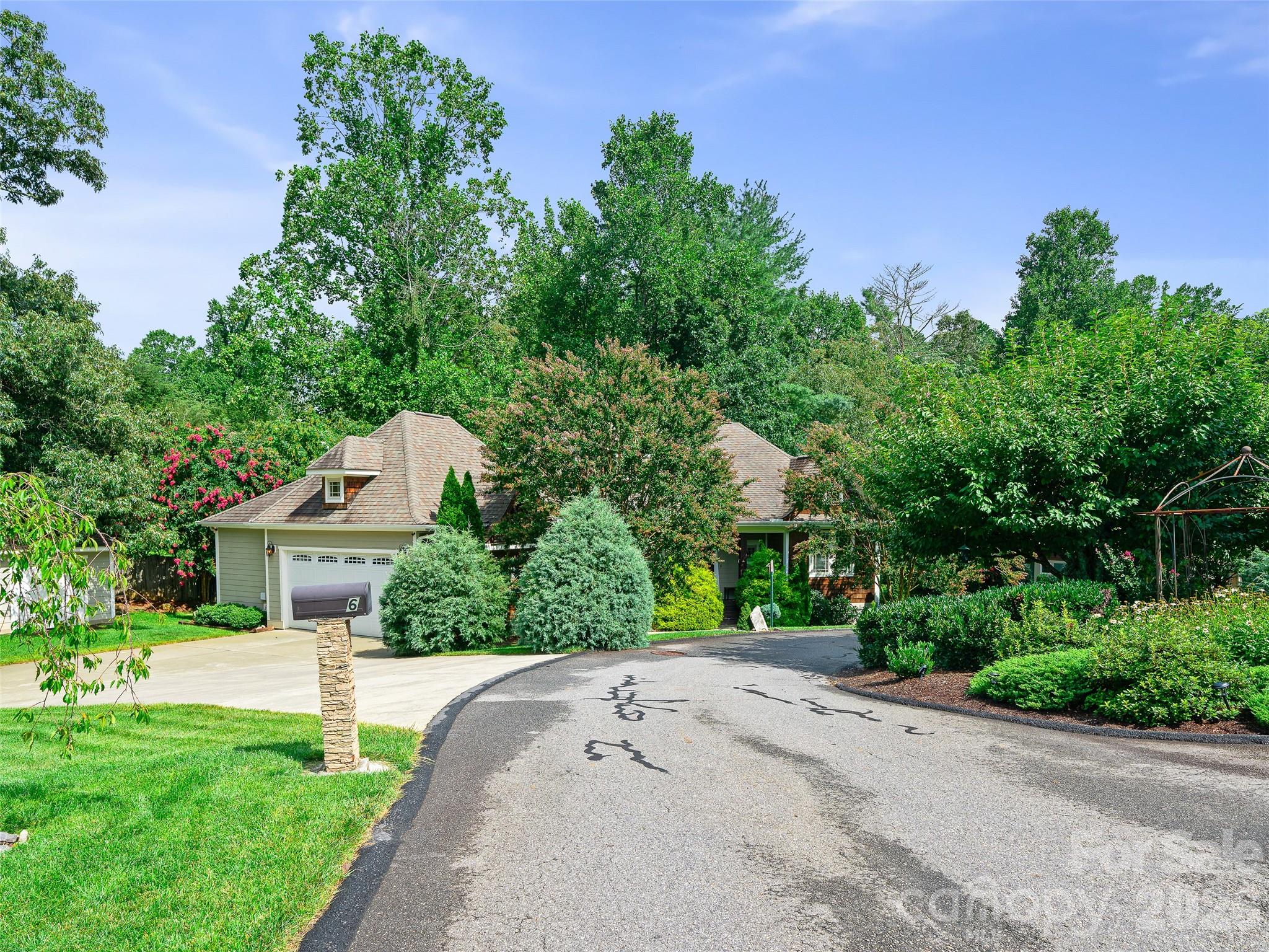 arts and crafts home tucked into the mature hardwoods and ornamentals - 6 Oak Springs Drive, Arden