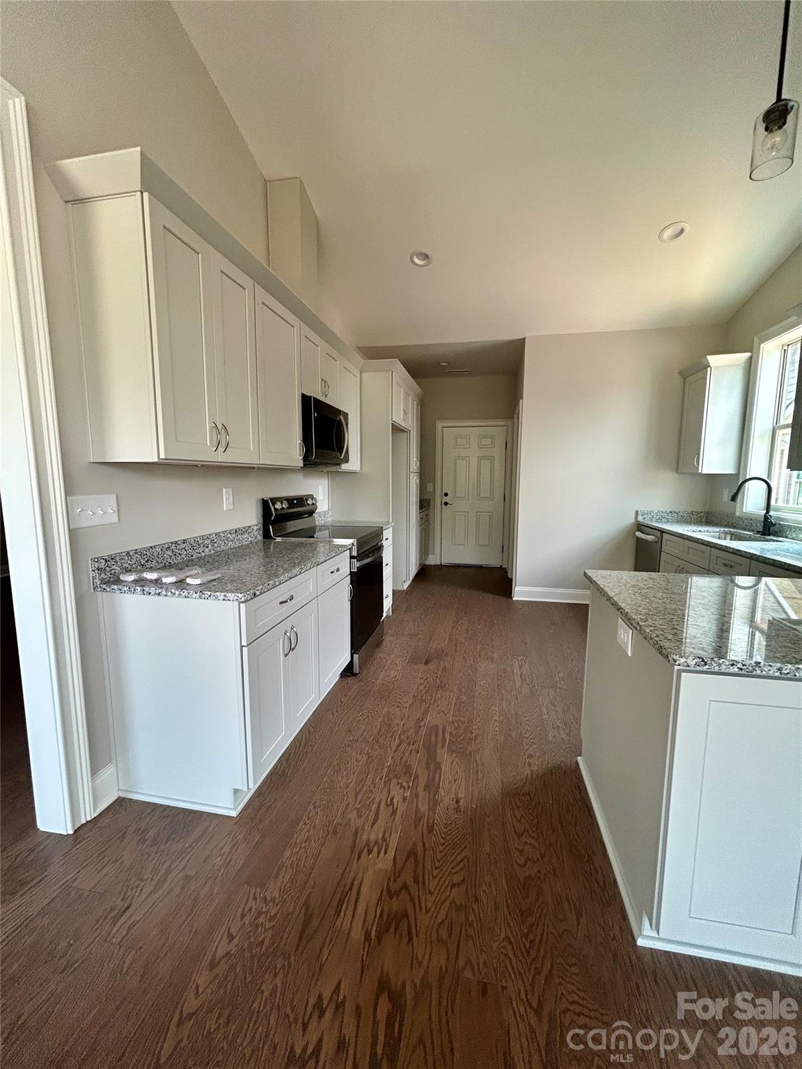 Kitchen with exit to garage. Utility room for washer and dryer. - 831-A Wynnshire Drive, Hickory