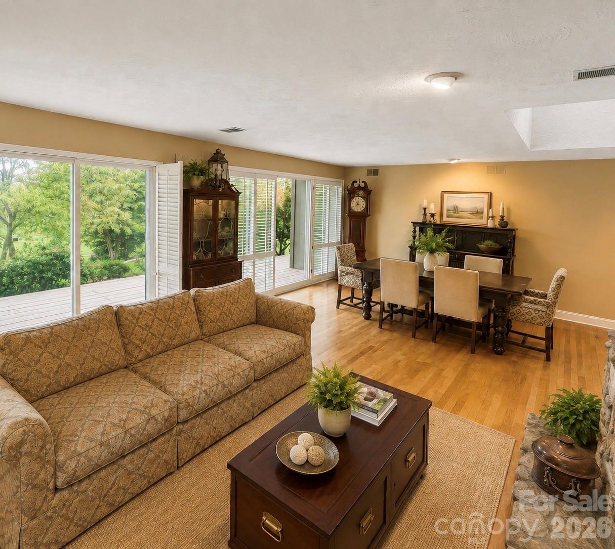 Living Room and Dining area with a wall of windows looking out to the golf course - 4821 Elmhurst Drive NE, Hickory