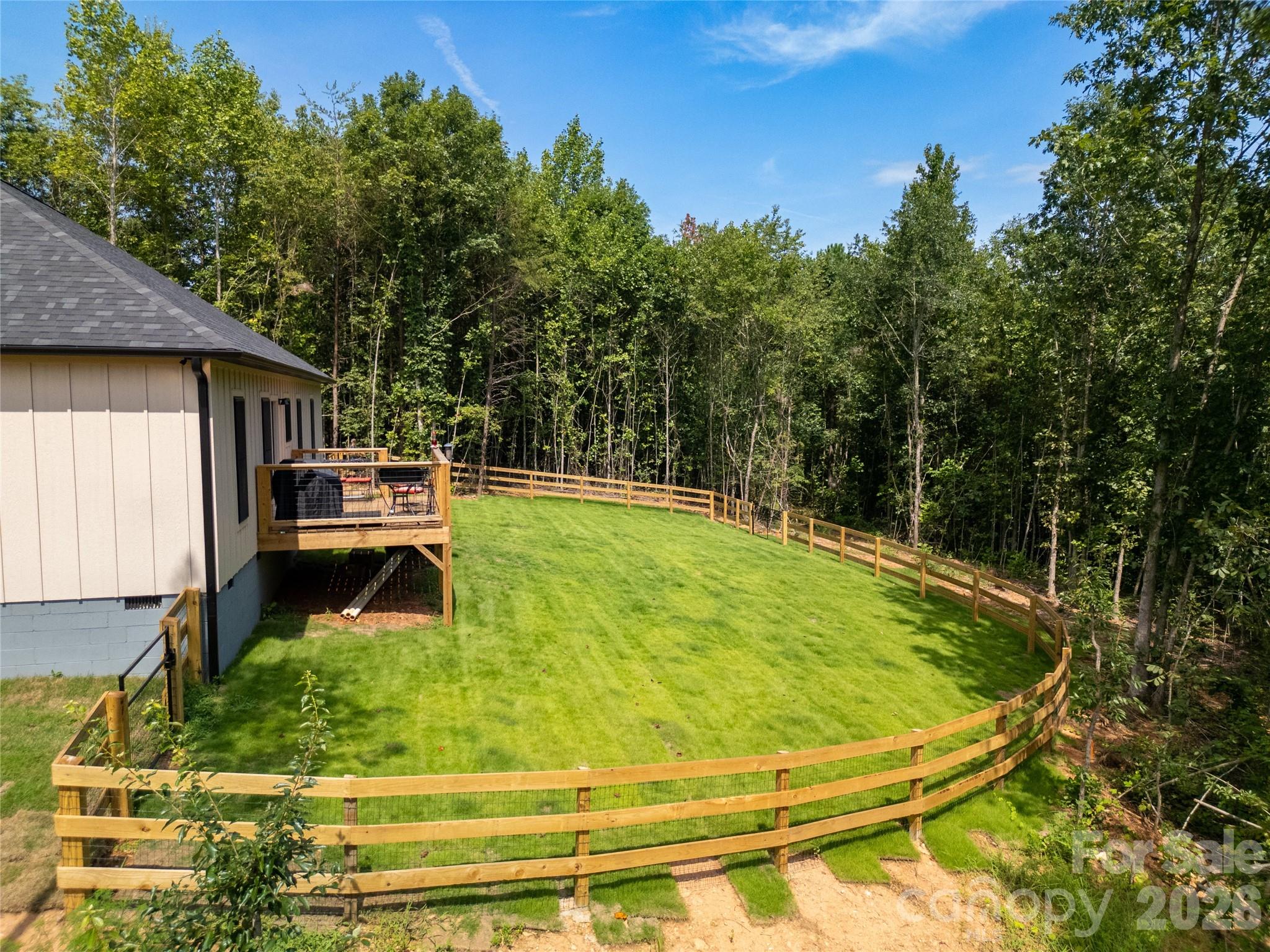 Back yard from the air on the right side of the house.! New rear deck and new canine ready fenced area.! - 98 Lexxi Lane, Tryon