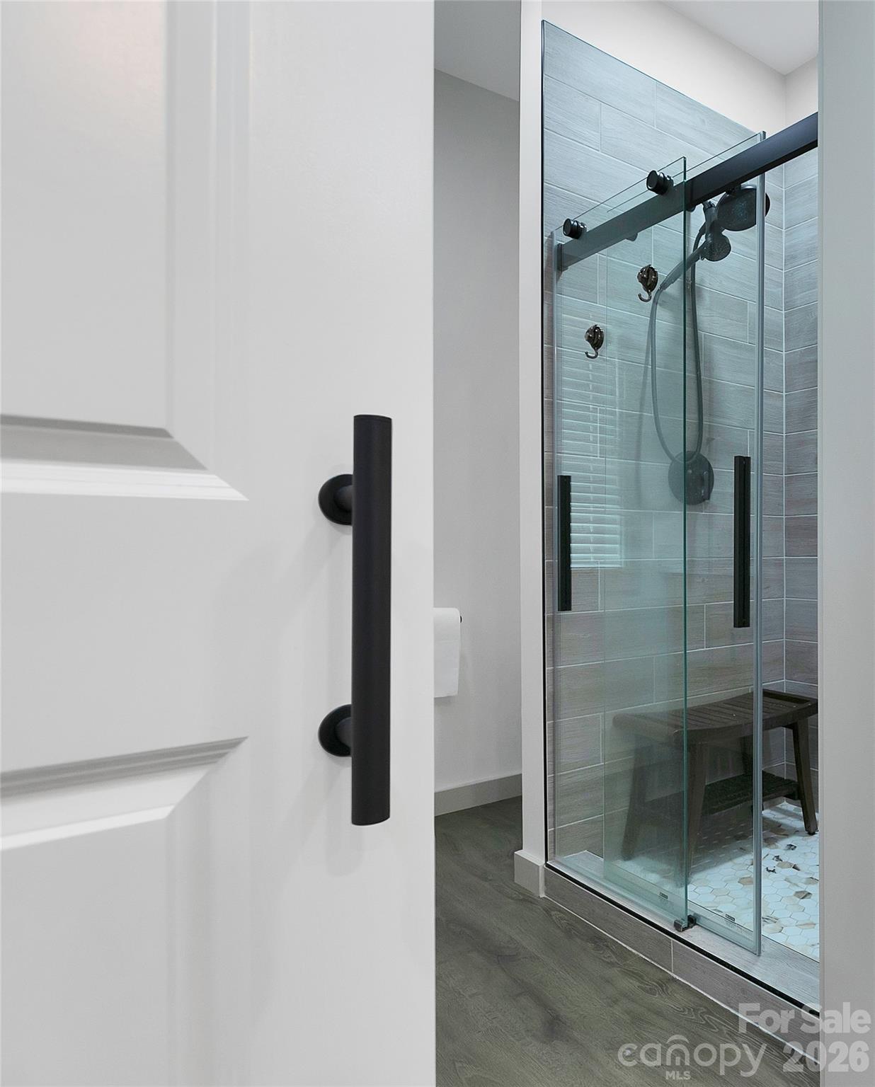 The Upgraded Glass Shower Door and the Entry Barn Door to the primary bathroom are very unique! - 98 Lexxi Lane, Tryon