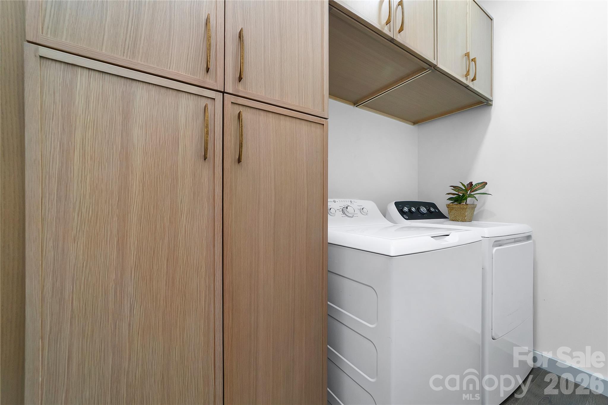 The laundry room has custom shelving and lots of cabinet storage space! - 98 Lexxi Lane, Tryon