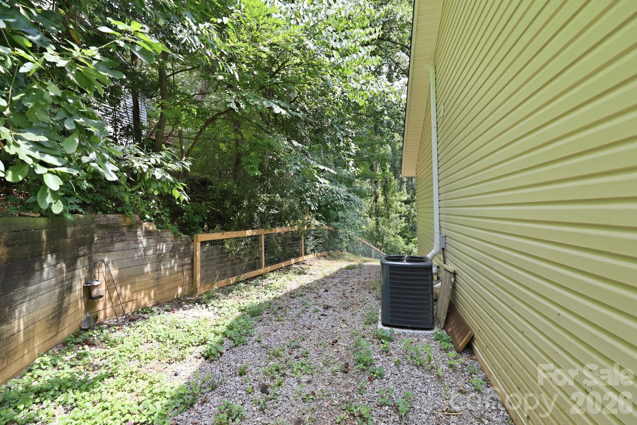 Fenced side yard connects backyard with front porch - 16 Westwood Drive, Candler