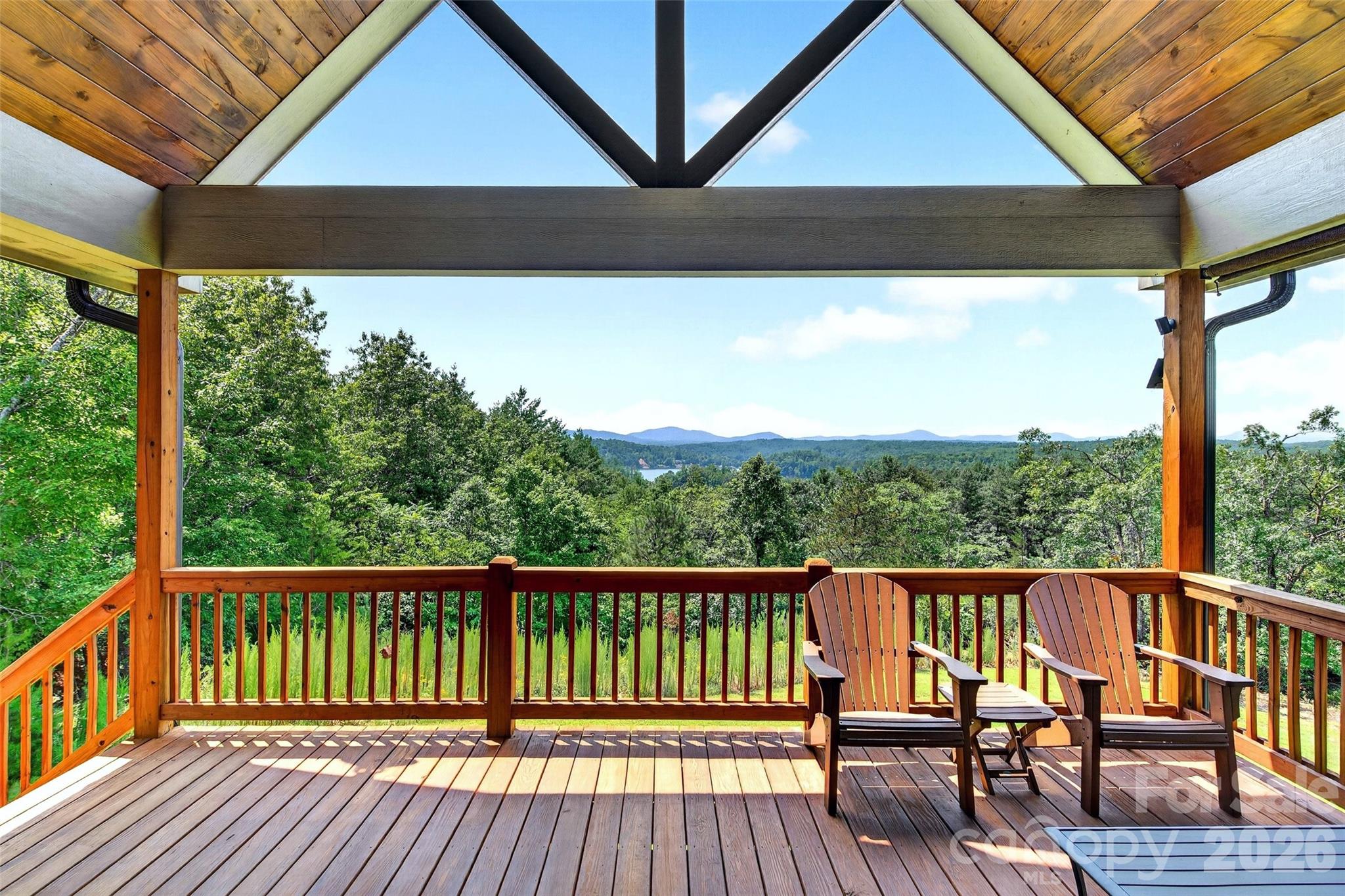 Covered rear porch under a vaulted timber ceiling; year-round mountain and lake views - 207 Lake Crest Drive, Nebo