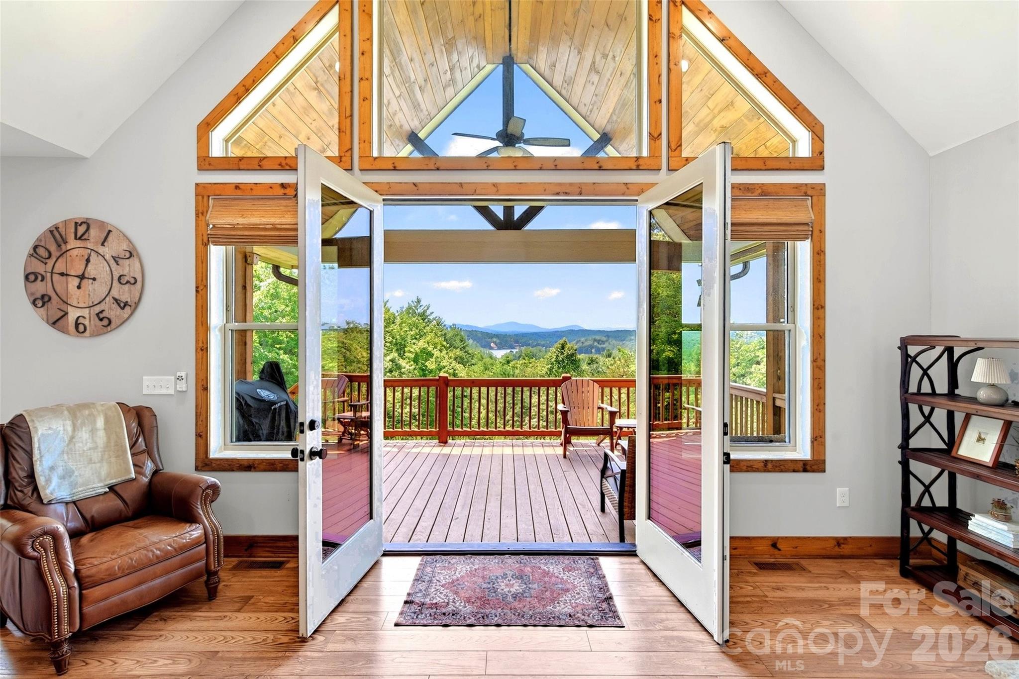 Open the great-room doors and the porch, the mountains, and Lake James are the whole view - 207 Lake Crest Drive, Nebo
