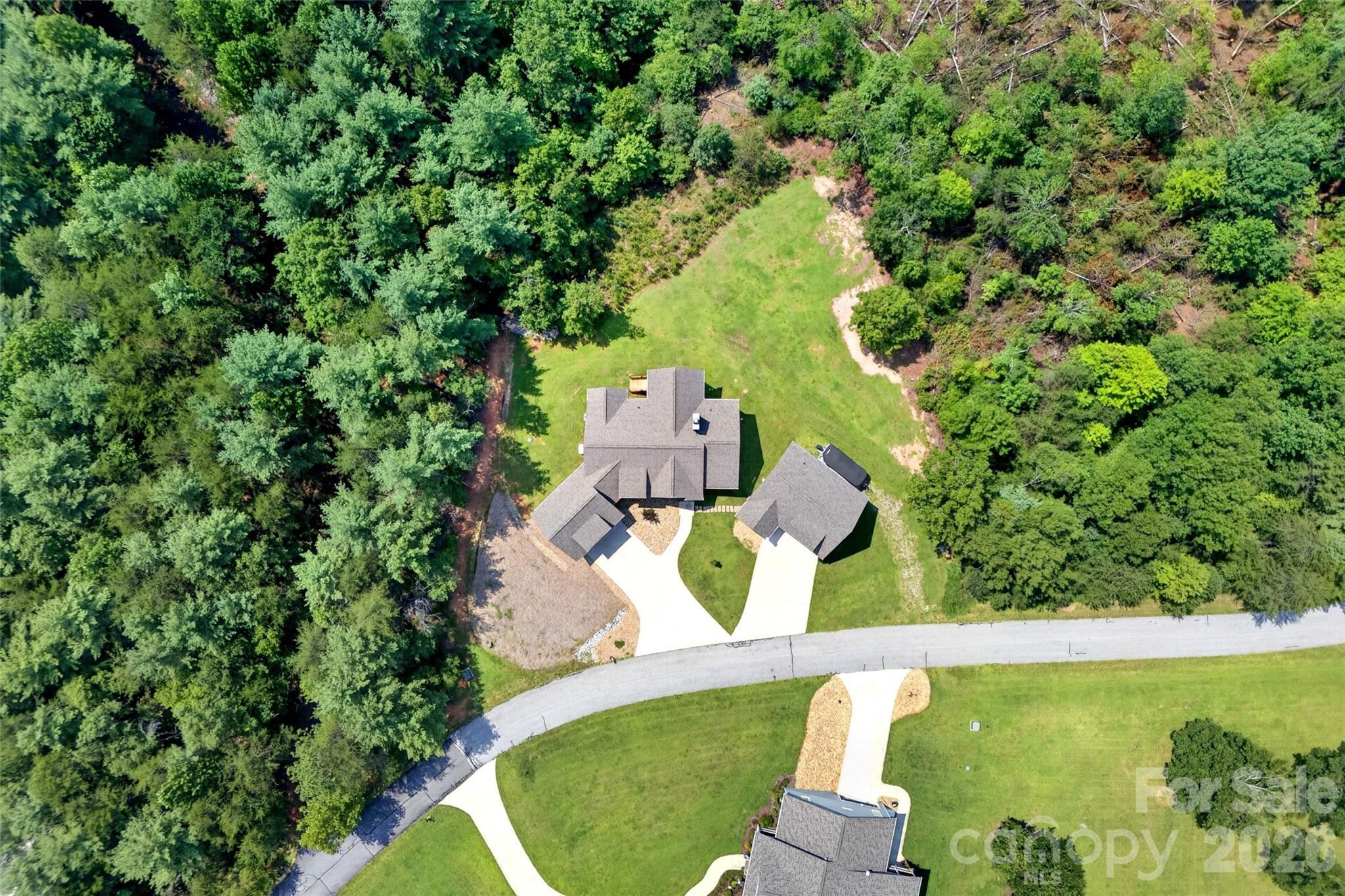 Aerial: rear of the home and the detached garage - 207 Lake Crest Drive, Nebo