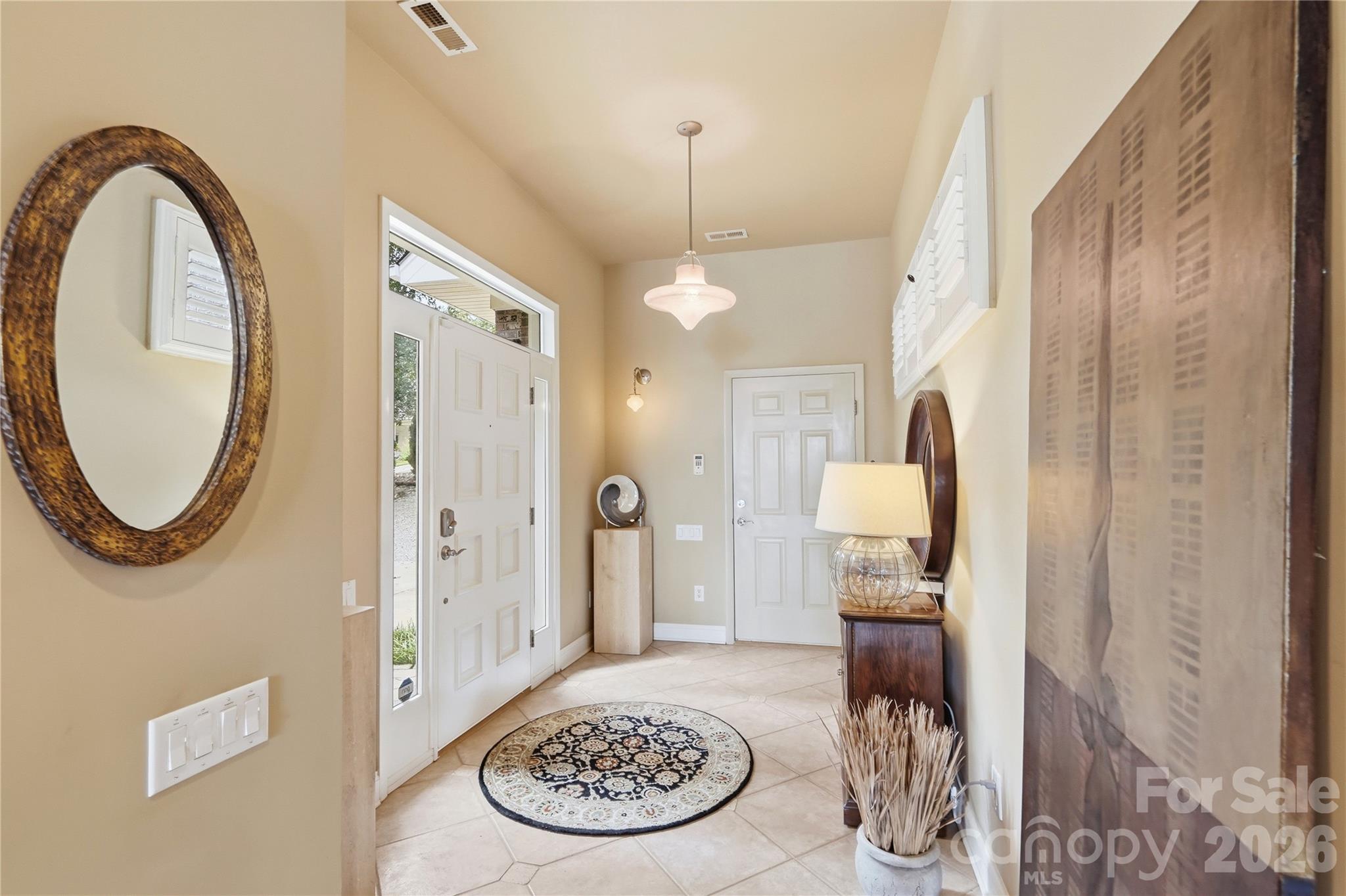 This custom built home boasts specialized features such as Italian lighting fixtures, lighting dimmers, sound system speakers on both levels and on screen porch - 1075 Lakefront Woods Drive, Belmont
