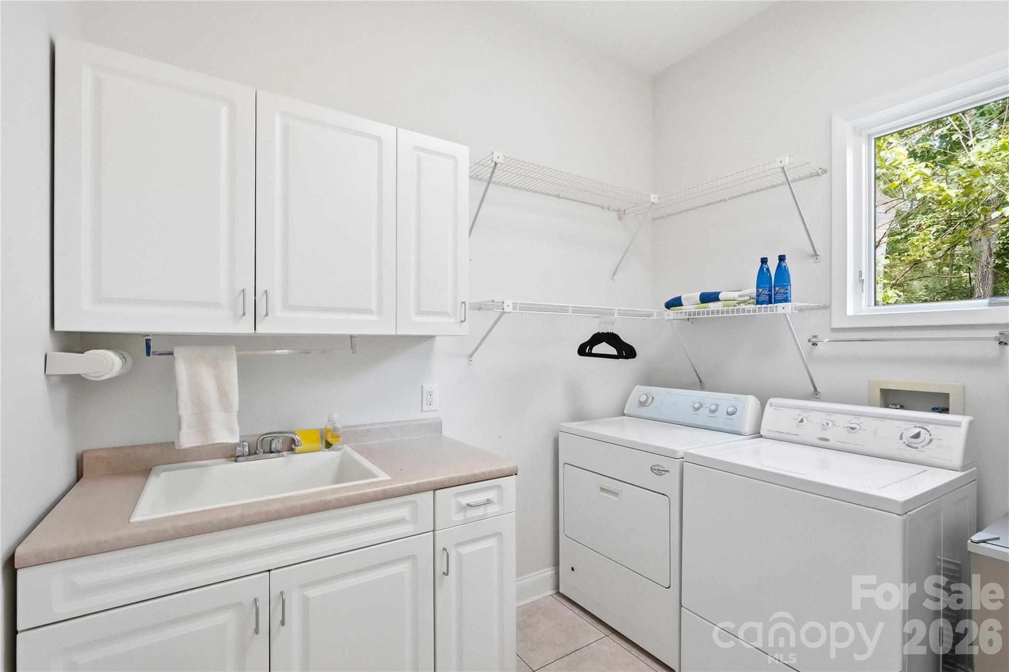 Spacious main level laundry with sink - 1075 Lakefront Woods Drive, Belmont