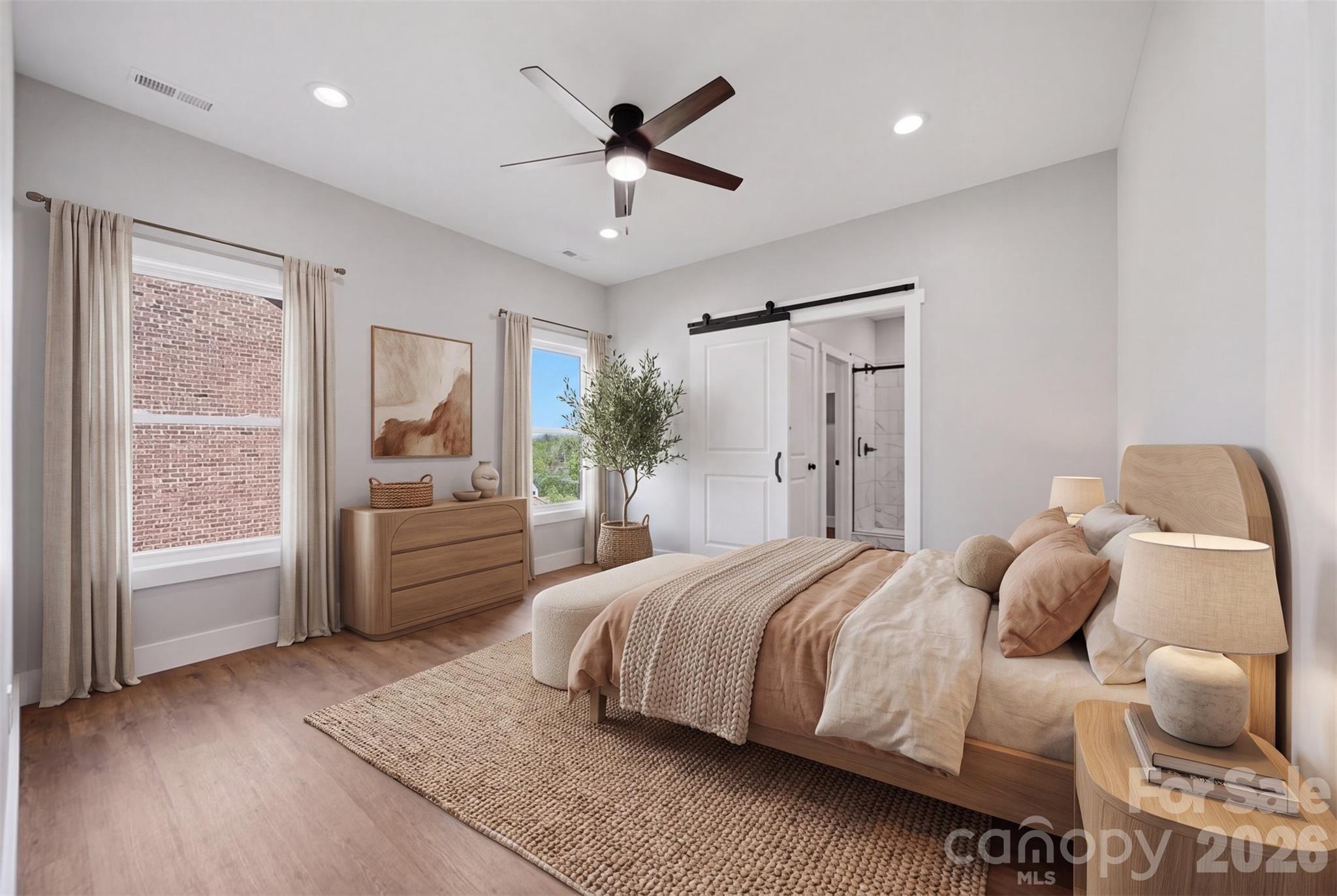 Primary bedroom. Virtually staged photo shows furniture placement. - 426 Huntington Woods Street SE, Lenoir
