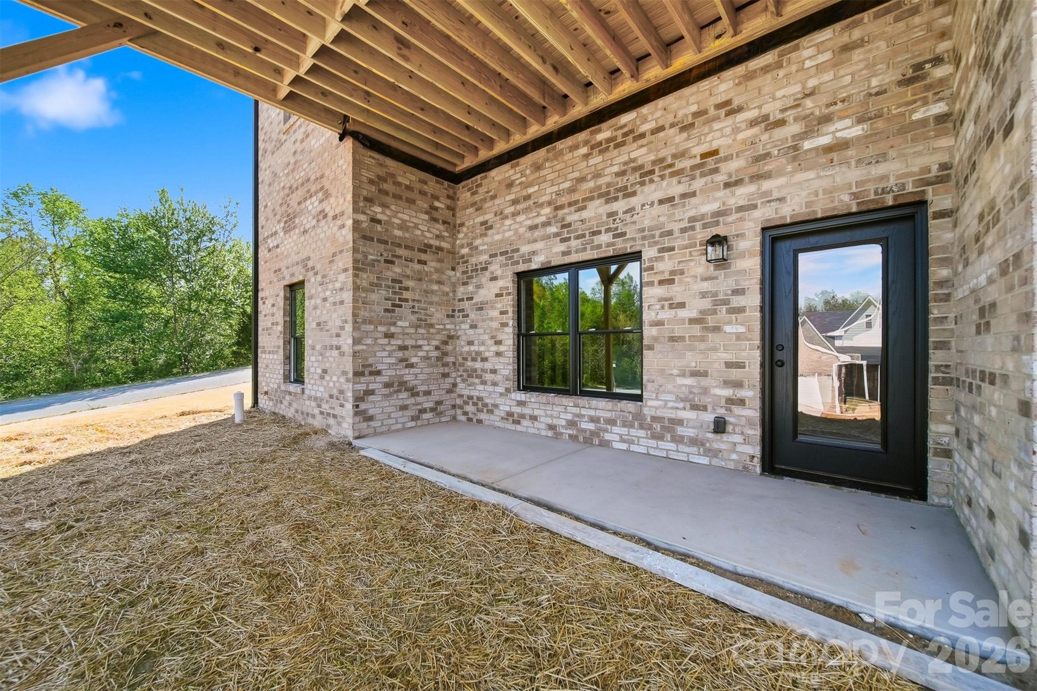 Walk out basement features a covered patio. - 426 Huntington Woods Street SE, Lenoir