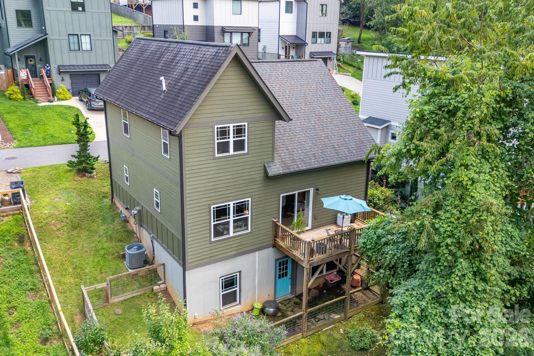 1.5 stories and a full daylight basement. Basement is framed and plumbed with electric and ductwork accessible. Homestays/ STR are allowed here. Buyer to verify. - 35 Emmett Lane, Asheville