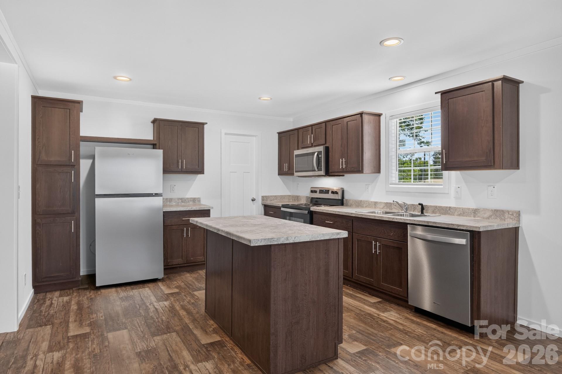 Kitchen with island and stainless steeel appliances - 1303 Elrado Street, Burlington