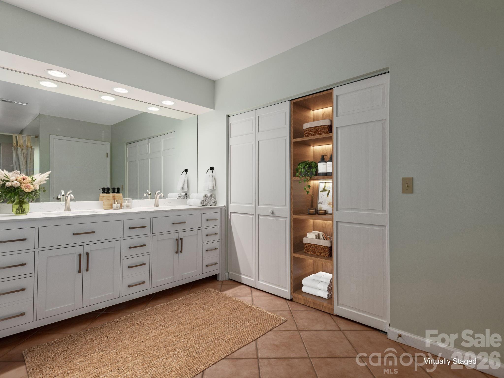 Virtually Staged - recreation room that extends outdoors to the deck and pairs perfectly with a private bath retreat featuring a jacuzzi tub and double vanity. - 1572 Brushy Fork Road, Sylva