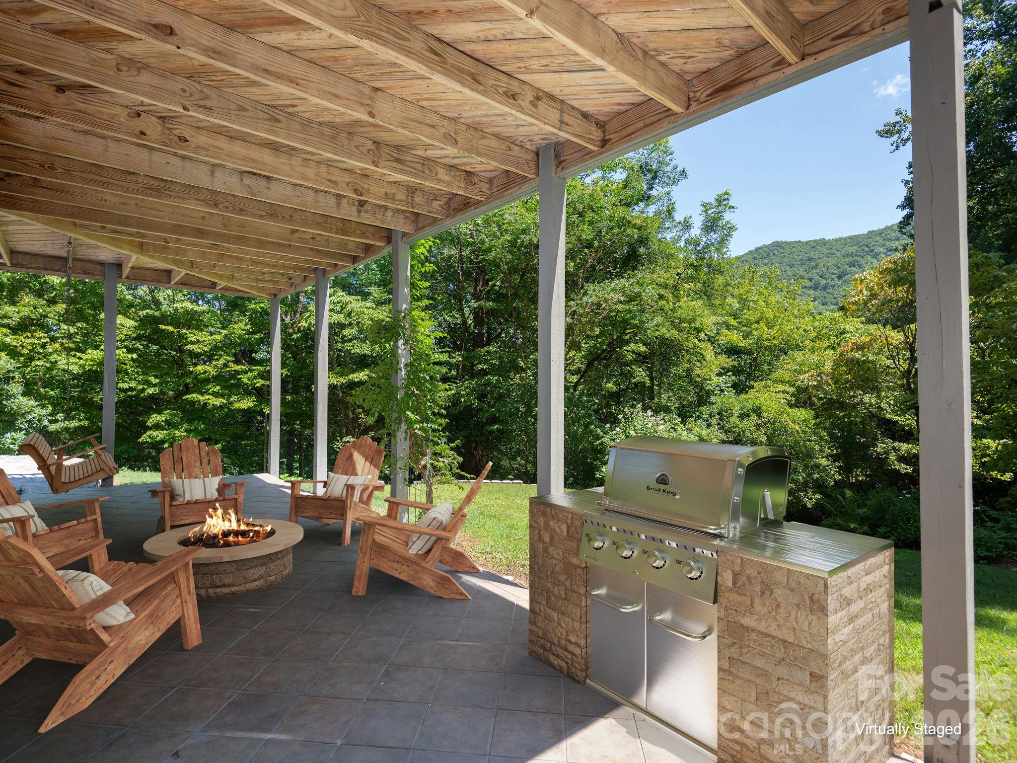Virtually Staged !!!!including grill. Private terrace just off the recreation room suite—creating the perfect indoor-outdoor retreat for relaxation and enjoyment. - 1572 Brushy Fork Road, Sylva