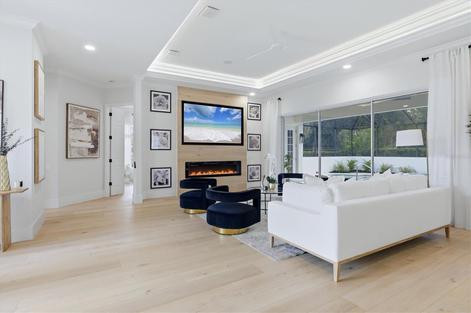 Living Room with Electric Fireplace and Feature Wall - 7825 WILTON CRESCENT CIR, BRADENTON