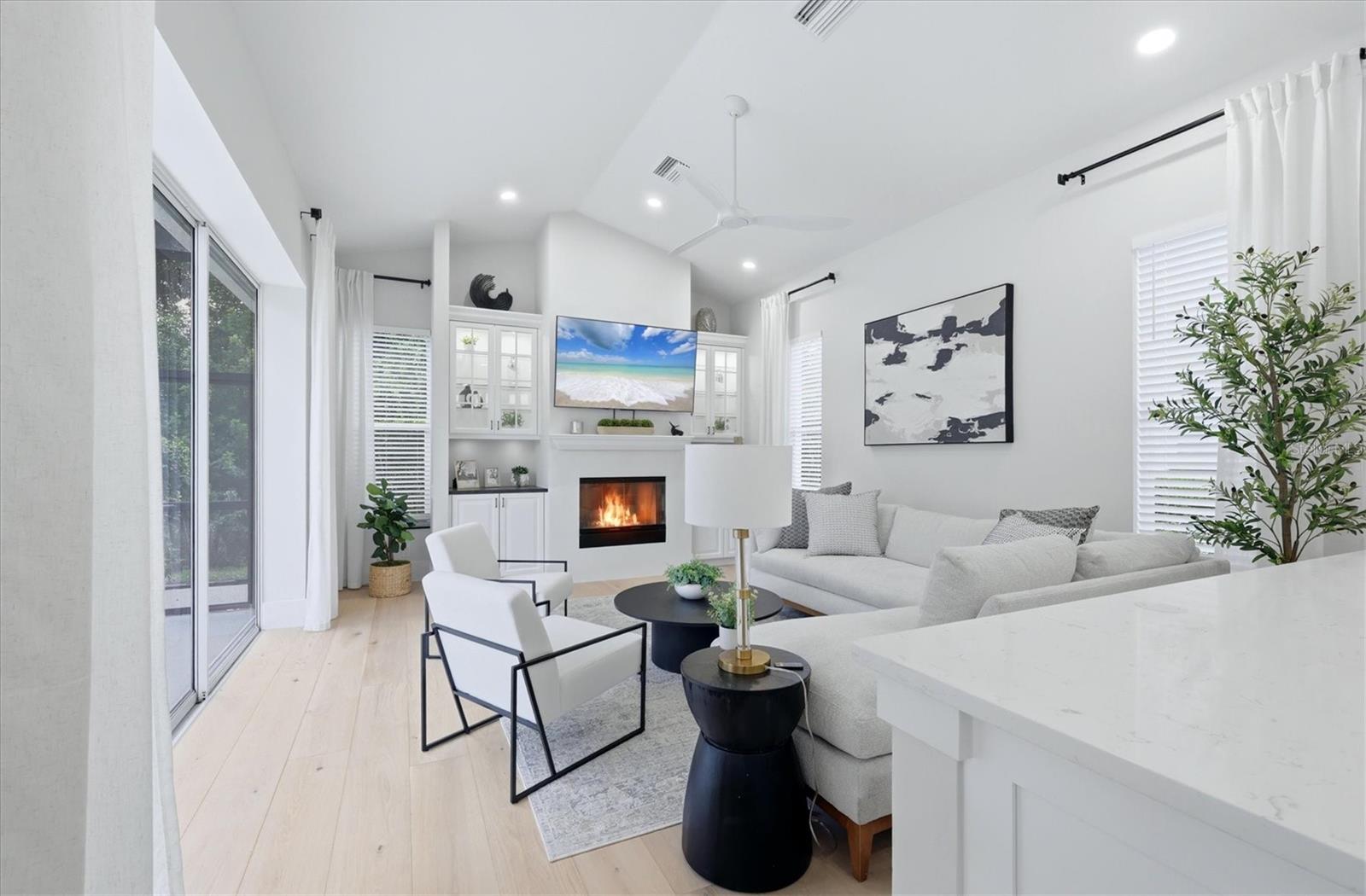 Family Room with Built-ins and Gas Fireplace on Feature Wall - 7825 WILTON CRESCENT CIR, BRADENTON