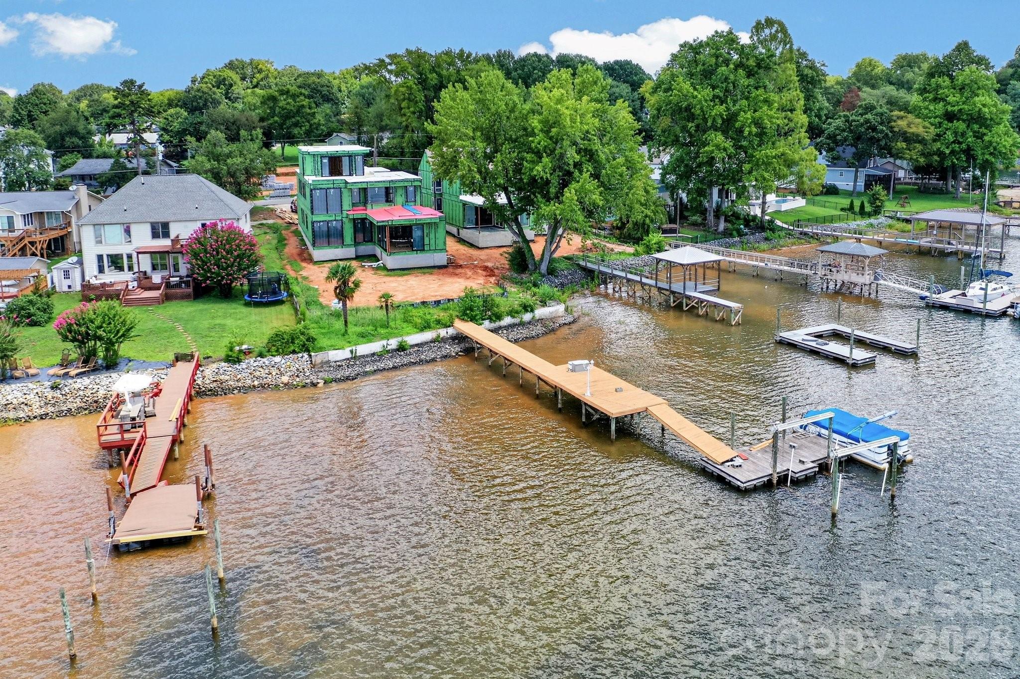 Aerial view of the back of the home with a dock and pier. - 21506 Rio Oro Drive, Cornelius