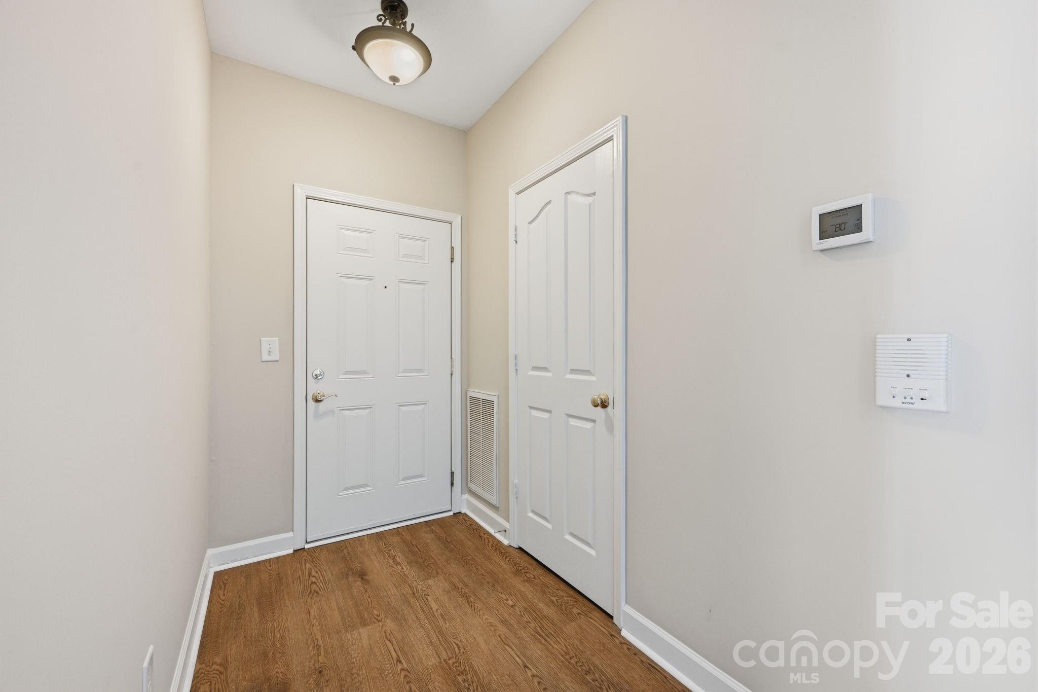 Entry greets you with fresh paint and Luxury Vinyl Plank (LVP) flooring throughout. Handy guest clost as well. - 16648 E Amberside Road, Cornelius