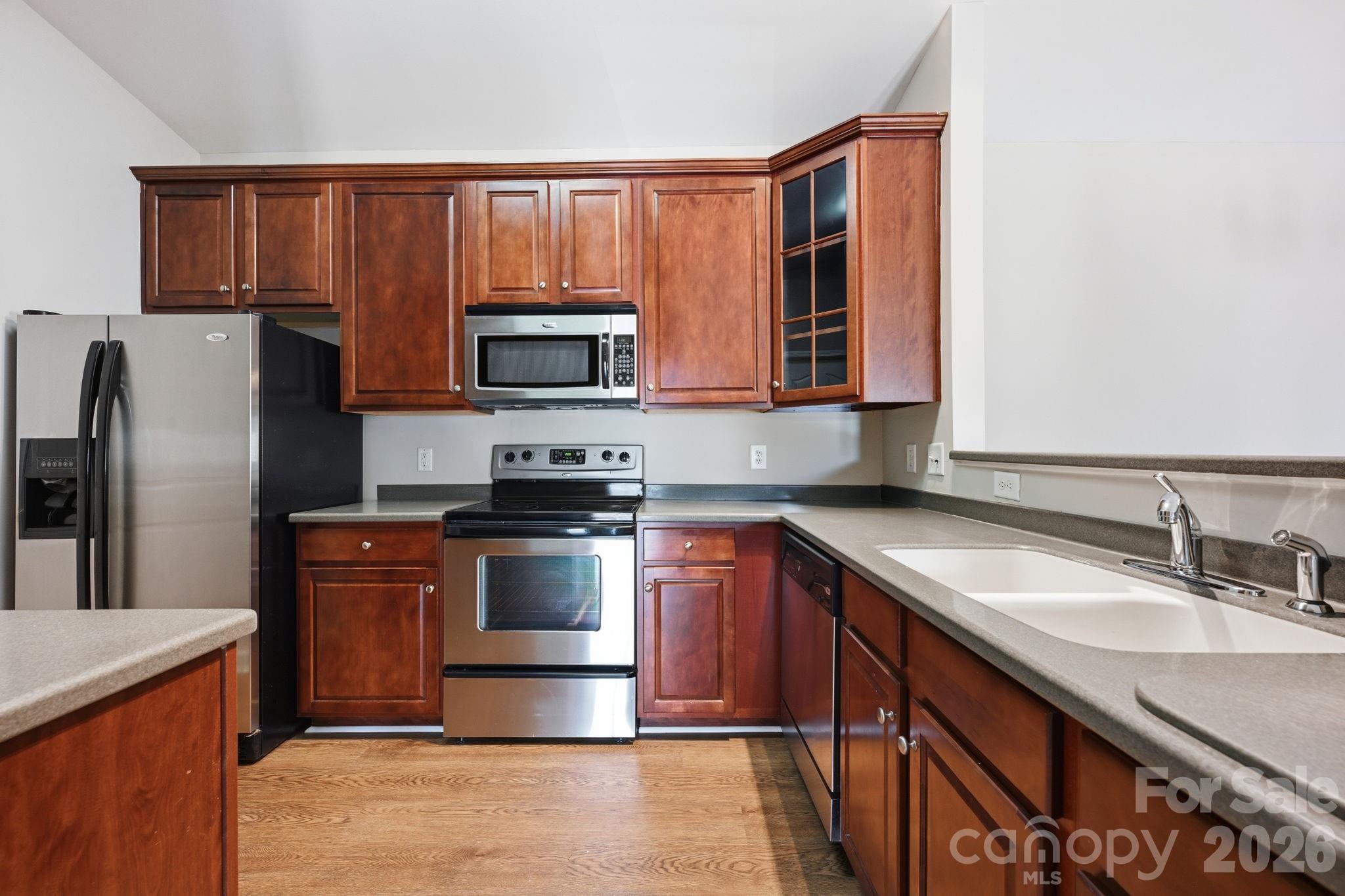 Spacious kitchen with stainless steel appliances. Beautiful cherry cabinets and plenty of work space. - 16648 E Amberside Road, Cornelius