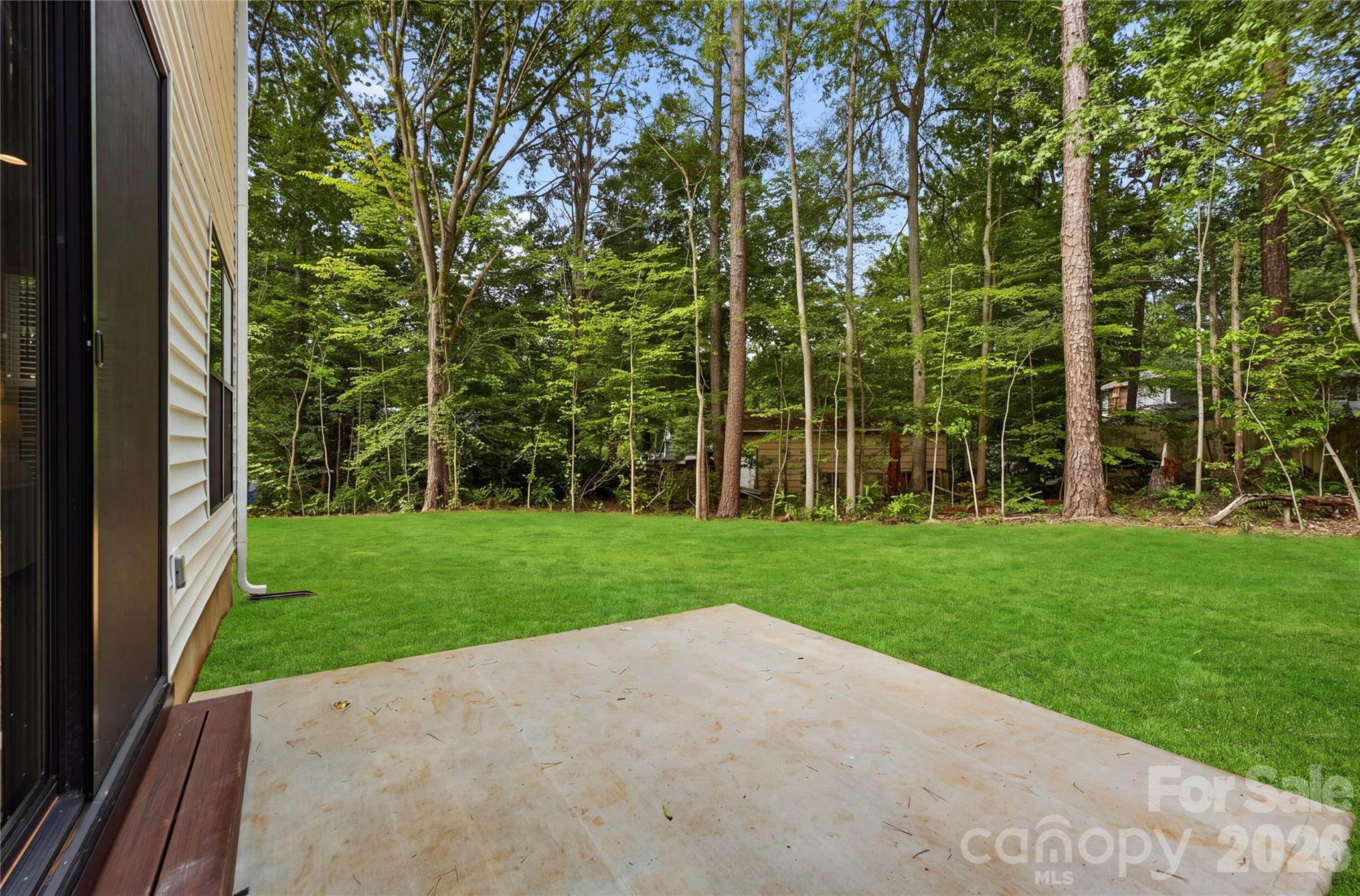 Rear patio. Lot has been seeded and strawed *grass digitally enhanced - 14133 Woodhurst Lane, Mint Hill