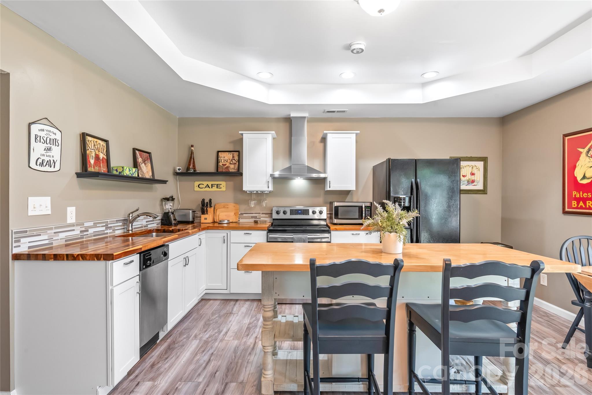 Second living area kitchen with butcher block counters and island with seating and storage - 2241 Indian Cross Trail, Matthews