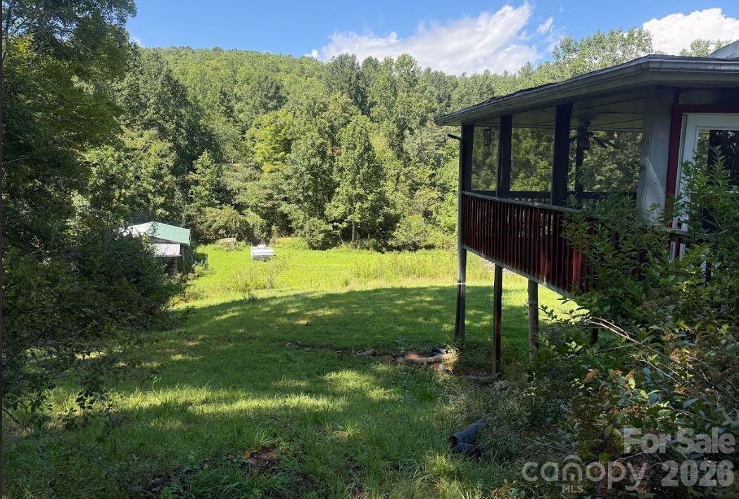 Side view of the home looking down in the field - 107 Flat Creek Drive, Lake Toxaway