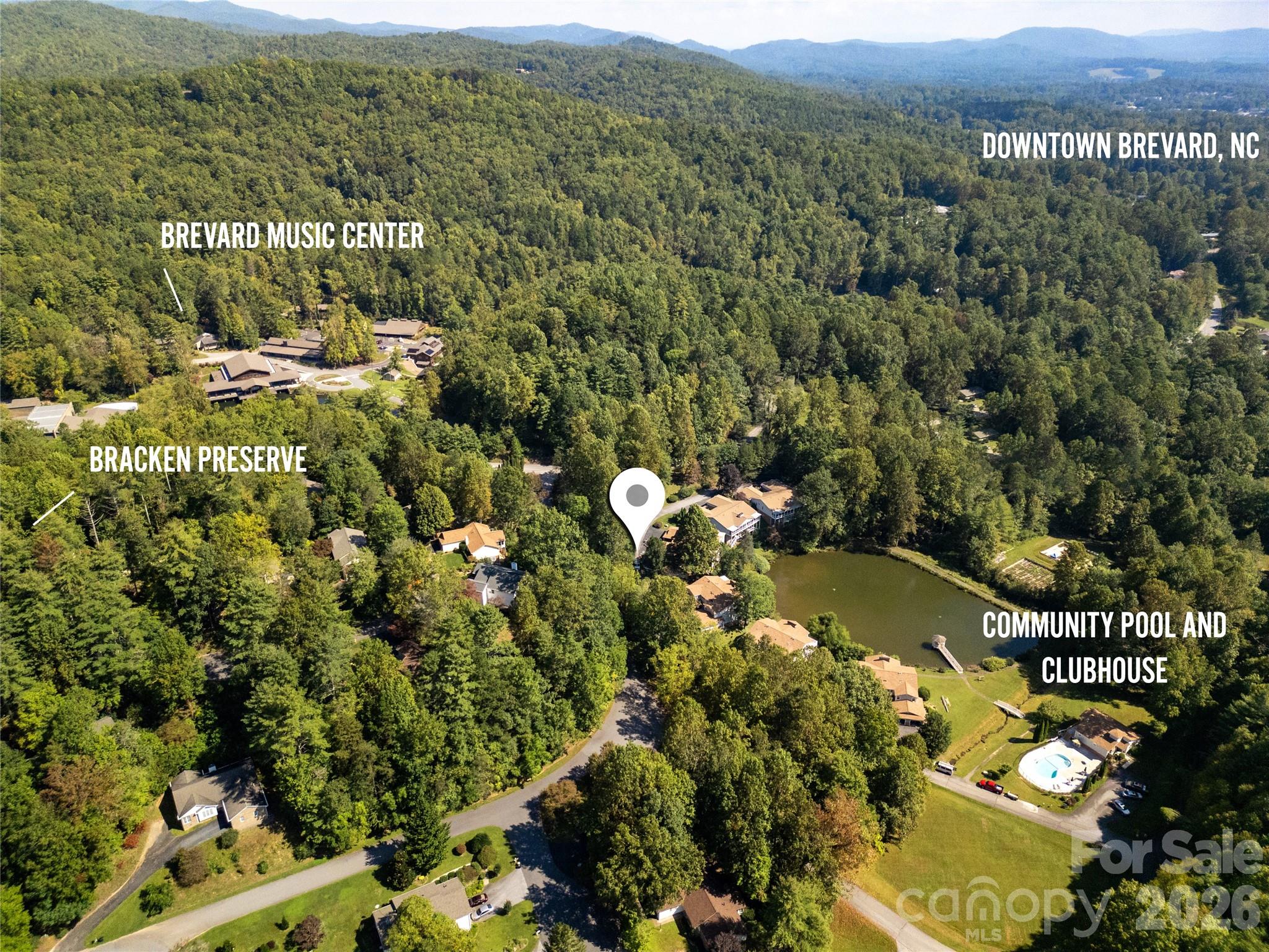 A bird’s-eye view showcasing the condo’s prime location in Waterford Place, with key landmarks labeled for perspective. The image highlights the proximity to Bracken Preserve, ideal for hiking and outdoor adventure; the Brevard Music Center, home to world-class summer performances; the Community Pool and Clubhouse: and Downtown Brevard, offering dining, shopping, and cultural experiences, all within easy reach of the condo. - 110 Lakeview Court, Brevard