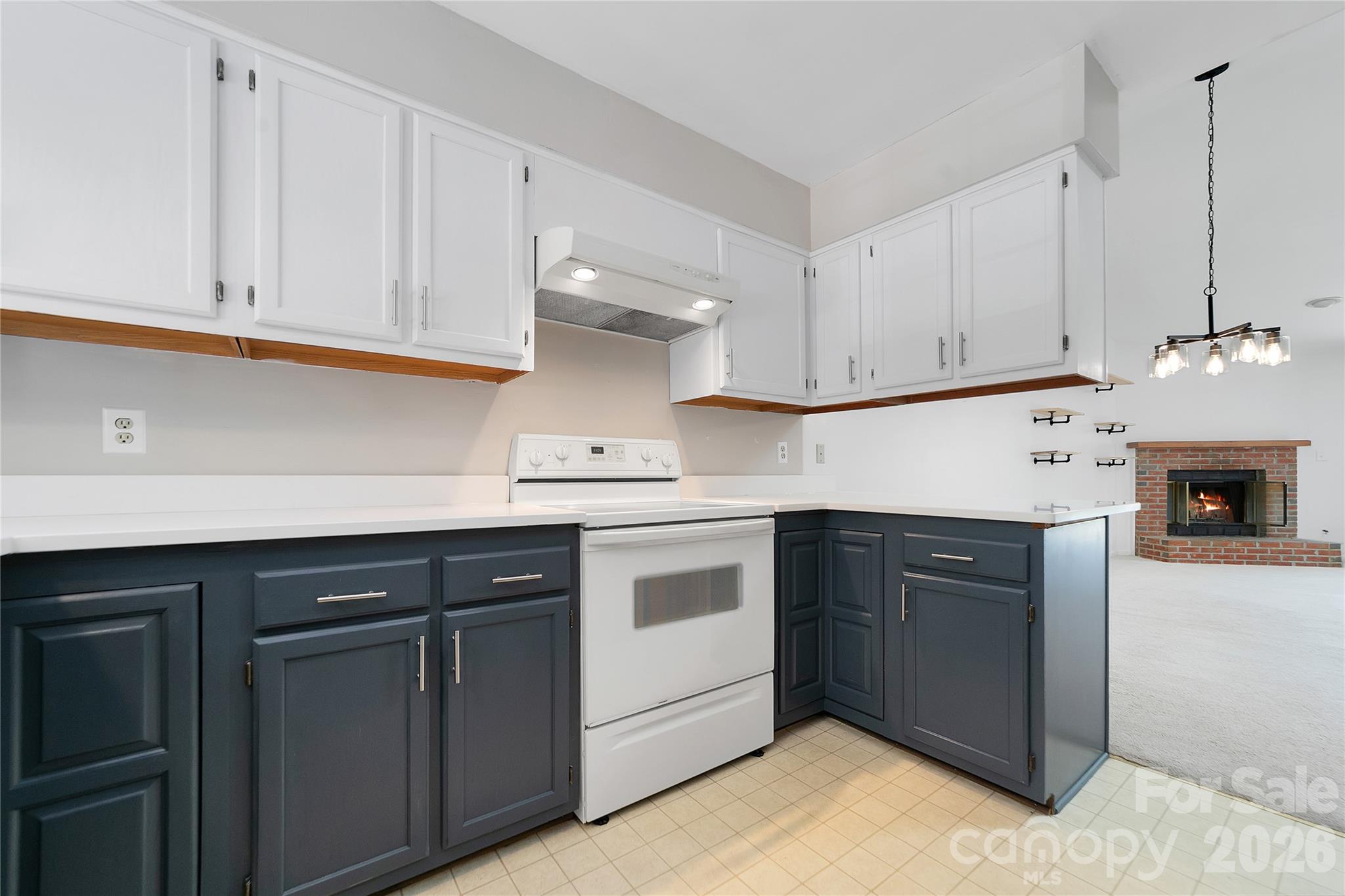 Entry to the kitchen is just inside the condo’s front door, opening directly into an inviting, open-concept layout that flows seamlessly into the living room. - 110 Lakeview Court, Brevard
