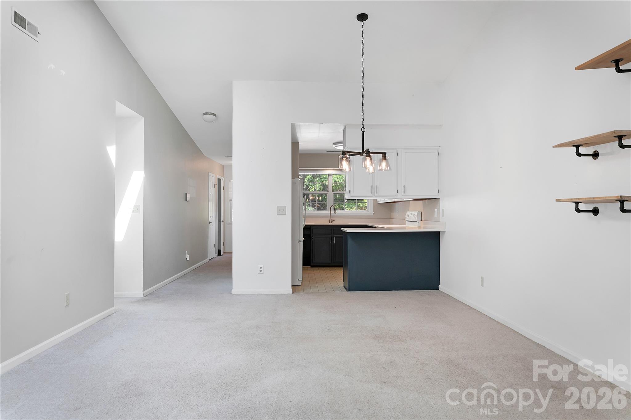 View of the Dining Area and Kitchen beyond from the Living Room. - 110 Lakeview Court, Brevard