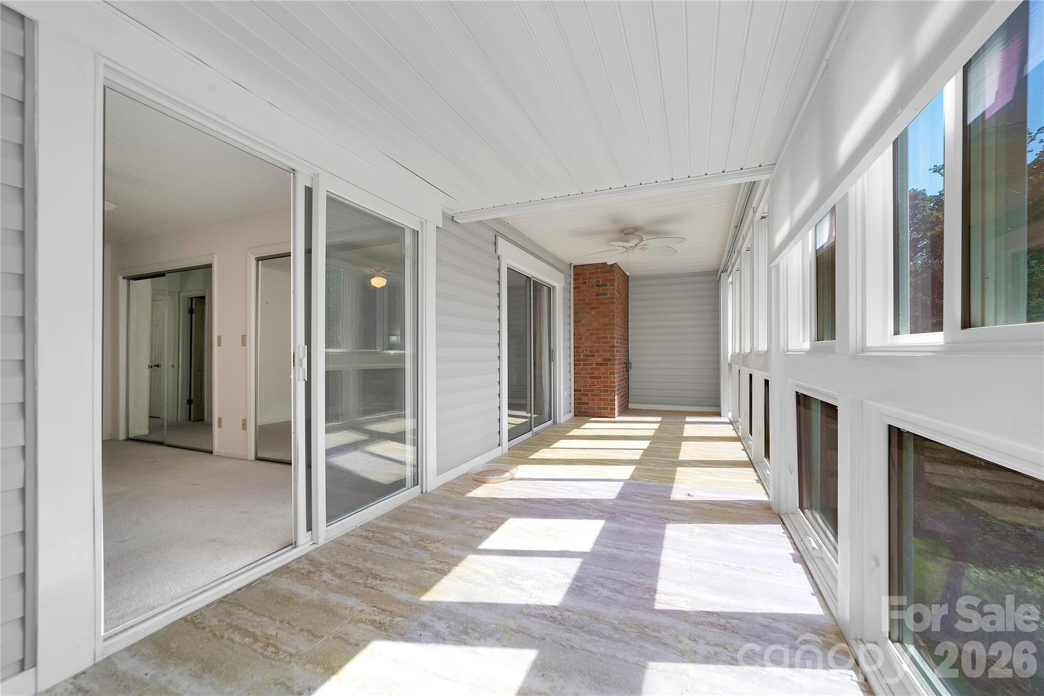 Sunroom has access from the Primary Bedroom as well as the Living Room. - 110 Lakeview Court, Brevard