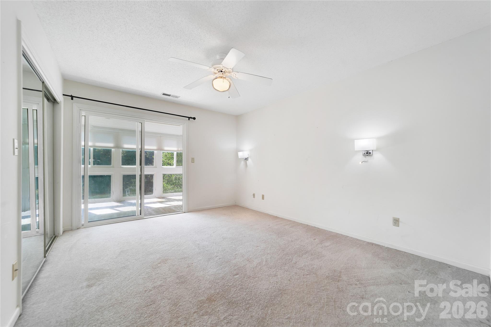Primary bedroom ensuite with access to the sunroom. - 110 Lakeview Court, Brevard
