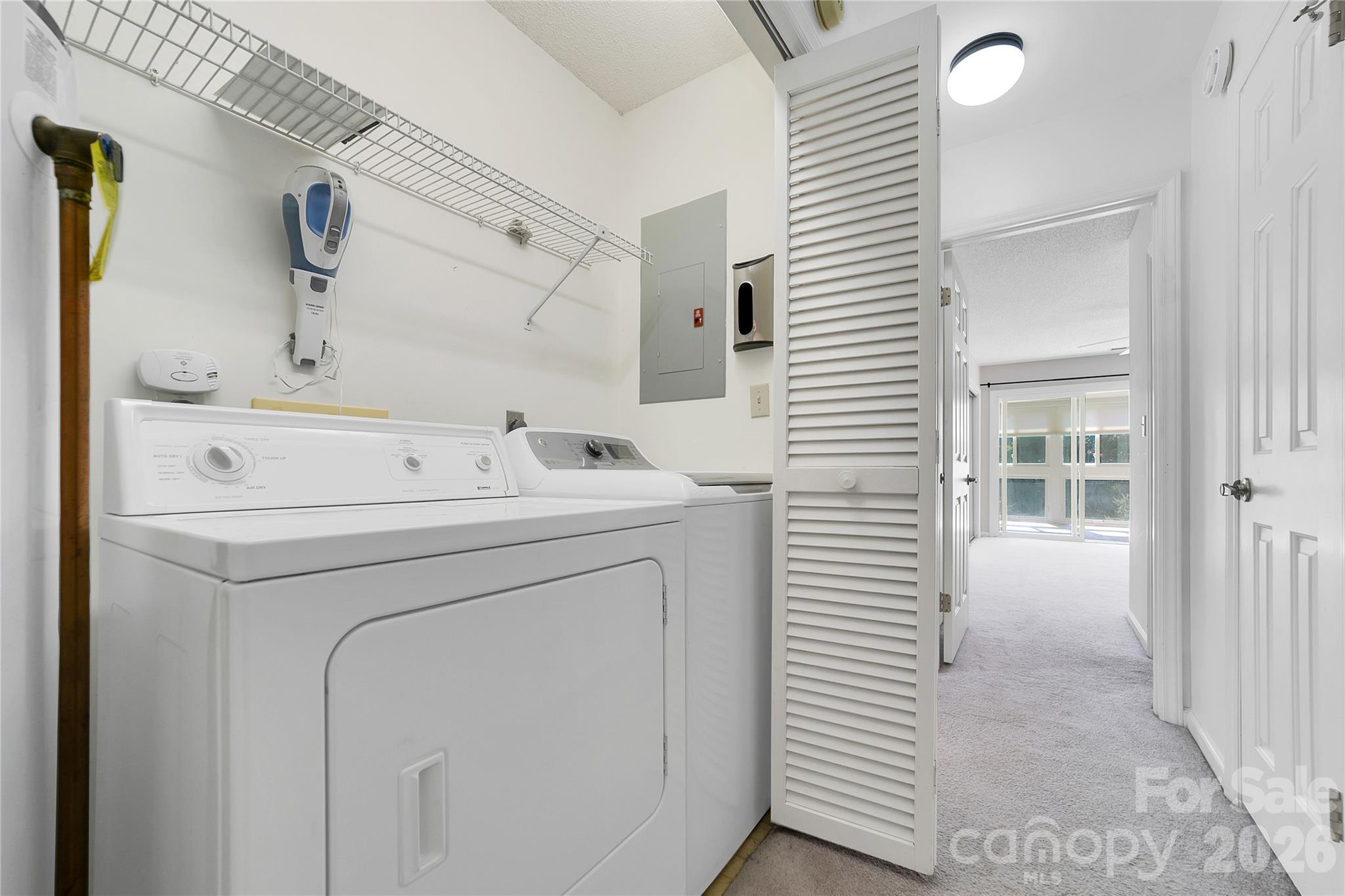 Laundry closet is in the hallway between bedrooms. - 110 Lakeview Court, Brevard