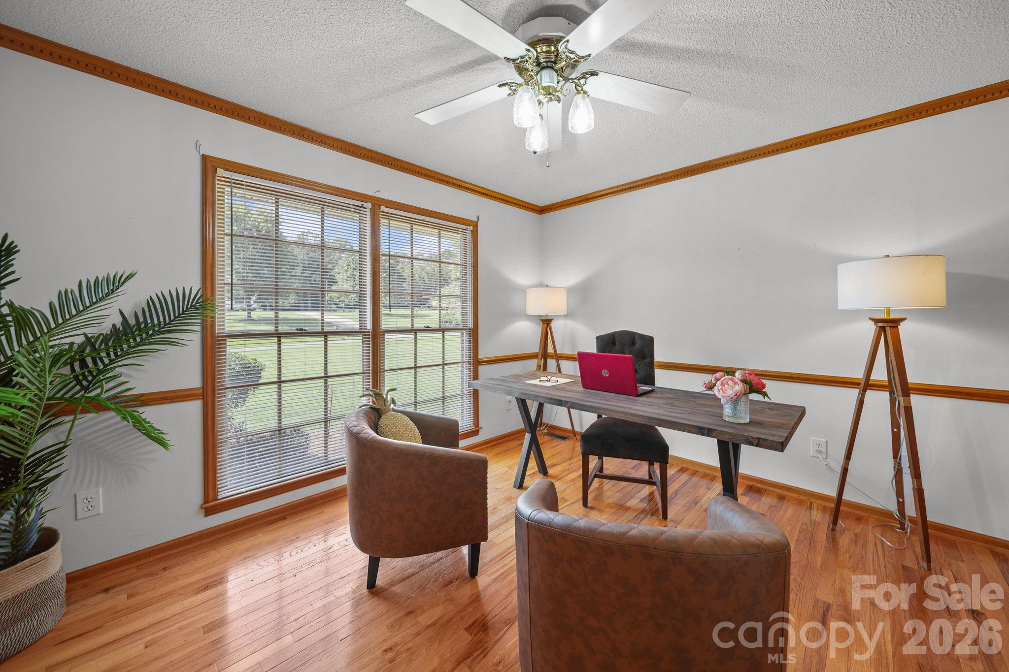 Windows provide natural light for this bedroom which has been staged as an office. - 3008 Eaker Drive, Cherryville