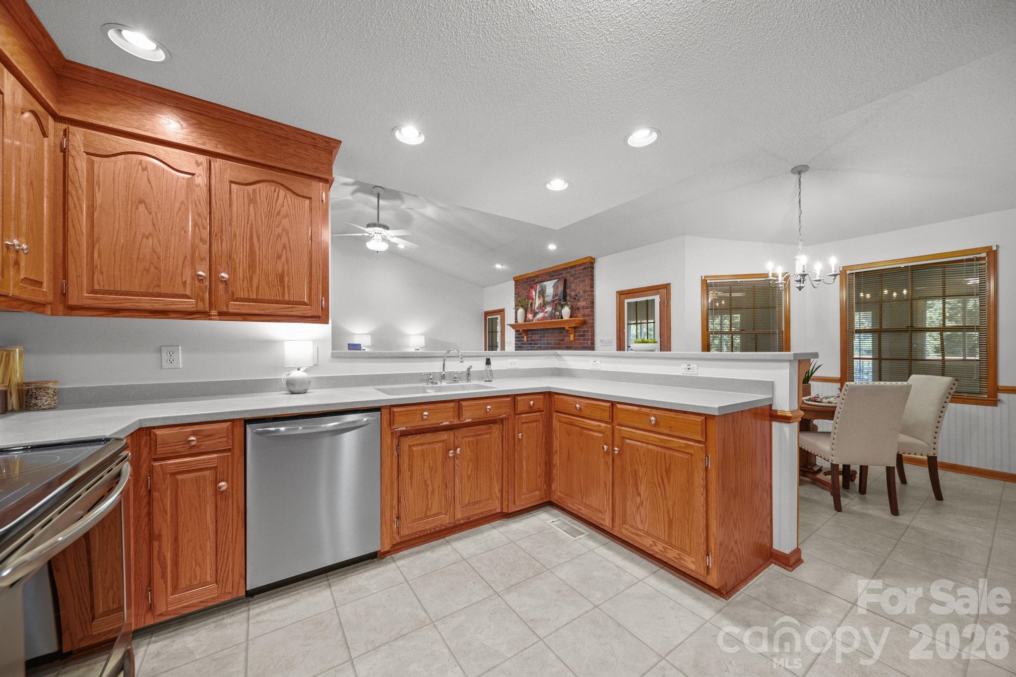 Lots of cabinet space for the gourmet meals you'll be preparing in this kitchen, with stainless steel appliances, recessed lighting, and an open layout to the family room. - 3008 Eaker Drive, Cherryville