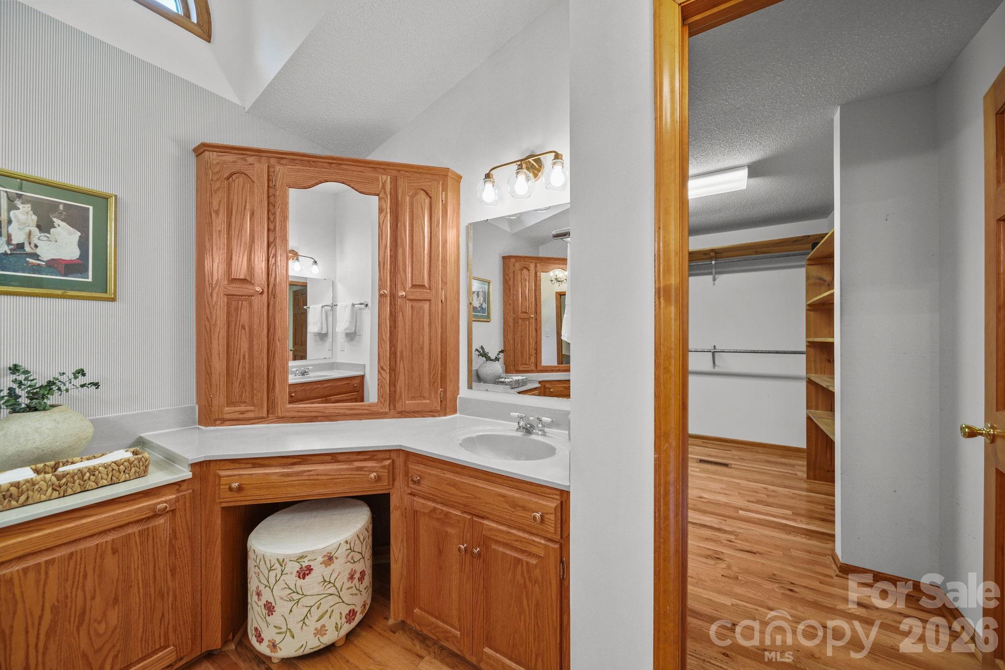 The primary ensuite has a pocket door separating it from the bedroom, two sinks, a large soaking tub, a tiled shower, and a huge closet! - 3008 Eaker Drive, Cherryville