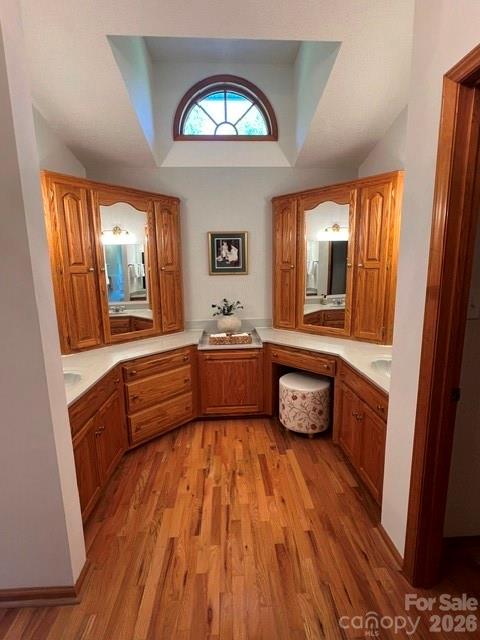 Primary bathroom with two sinks, vaulted ceiling, window for natural light, and plenty of cabinet space. There's also a built-in space for a clothes hamper. - 3008 Eaker Drive, Cherryville