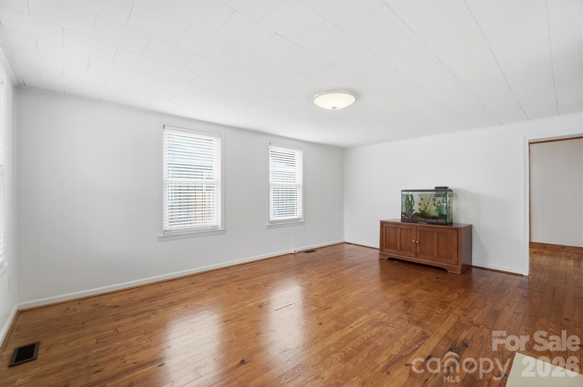 Original pine hardwoods in the living room and front two bedrooms, they add so much charm and have been well kept! - 412 Link Street, Fort Mill