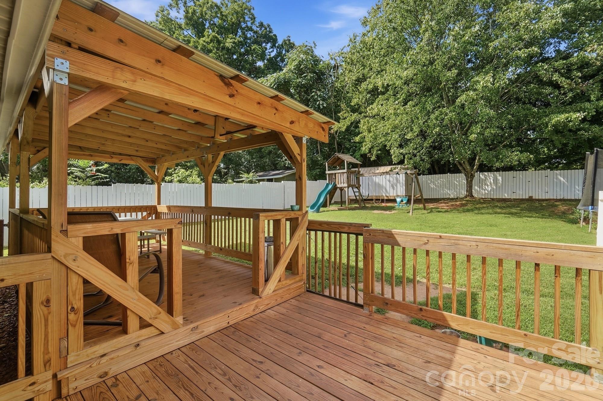 Large back deck space and a fully fenced-in backyard with side and back gates for easy access. - 412 Link Street, Fort Mill