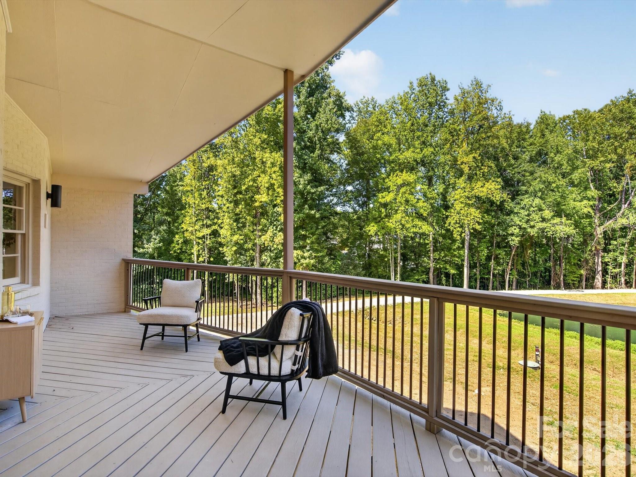 Covered outdoor living with pond views awaits. - 2532 Sam Newell Road, Matthews