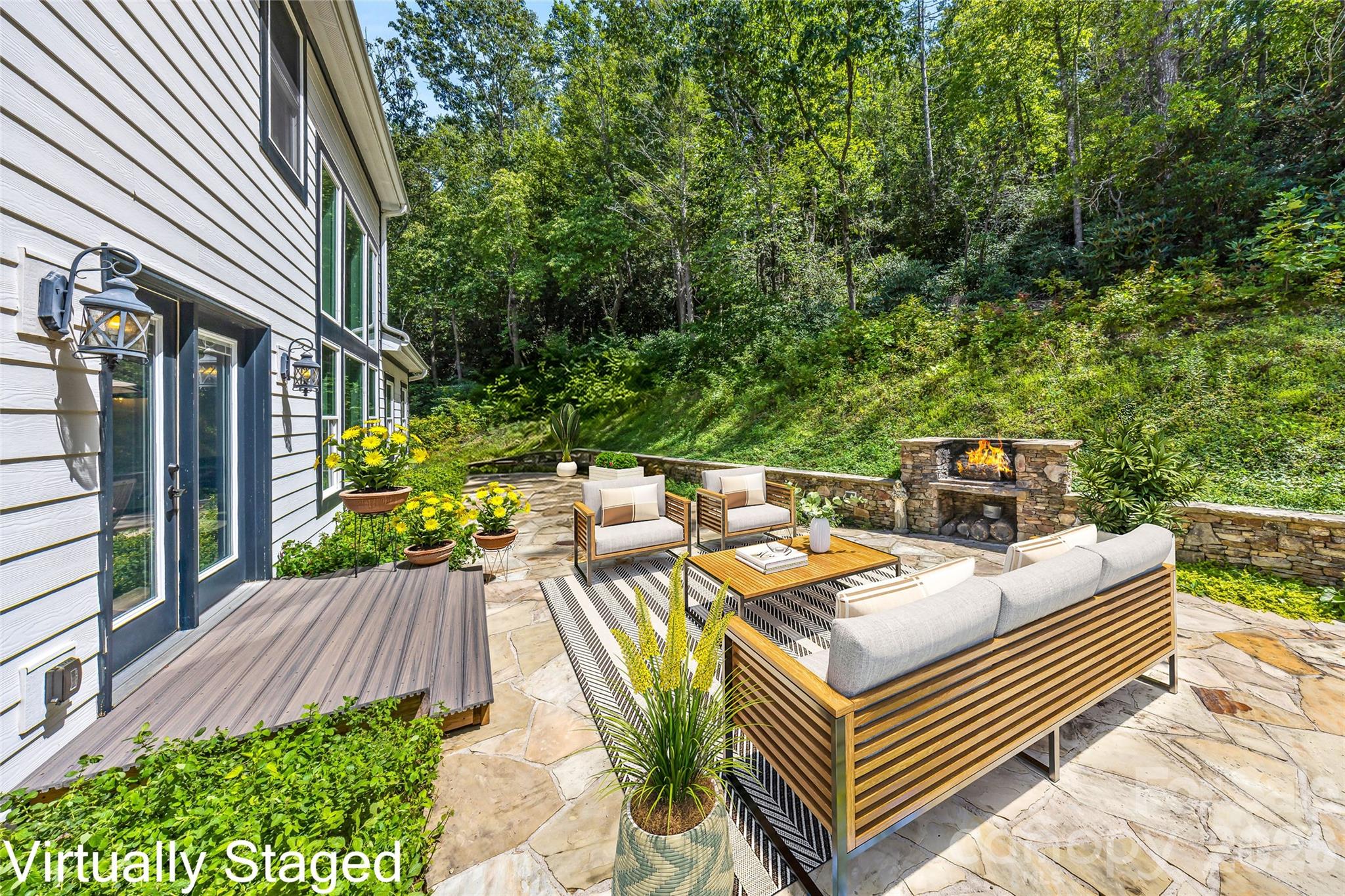 Stone patio with outdoor  fireplace - 820 Merrills Cove Road, Asheville