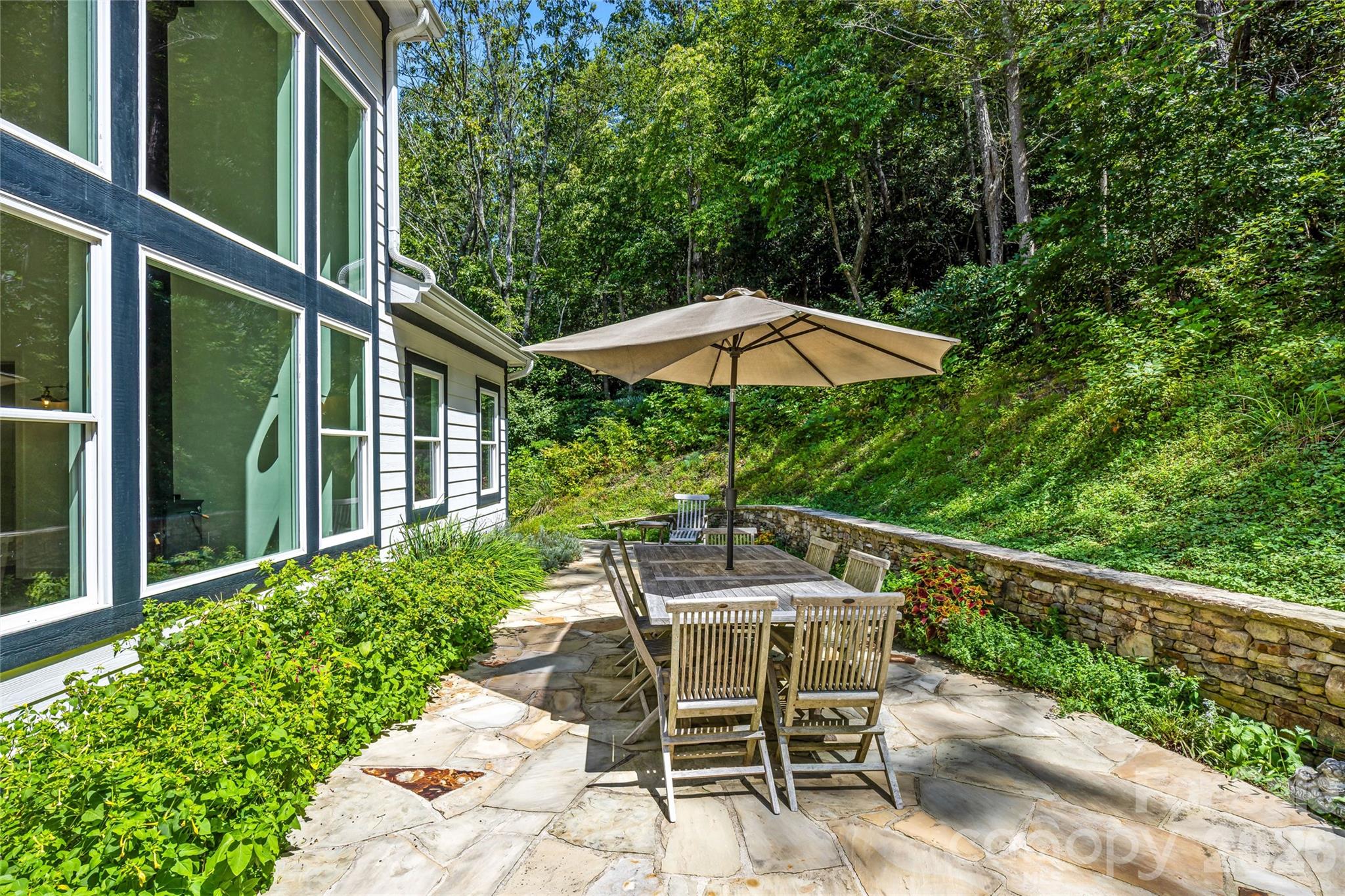 Stone patio surrounded by nature - 820 Merrills Cove Road, Asheville