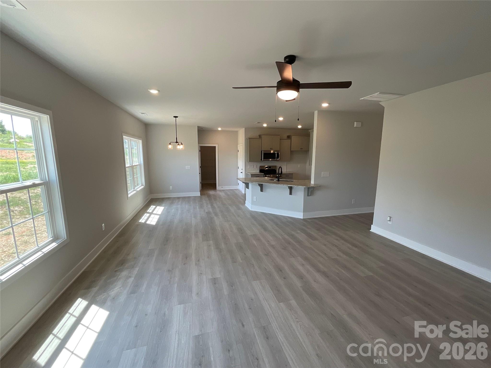 Family room looking into breakfast area and kitchen - 156 Kerr Walk Drive, Statesville