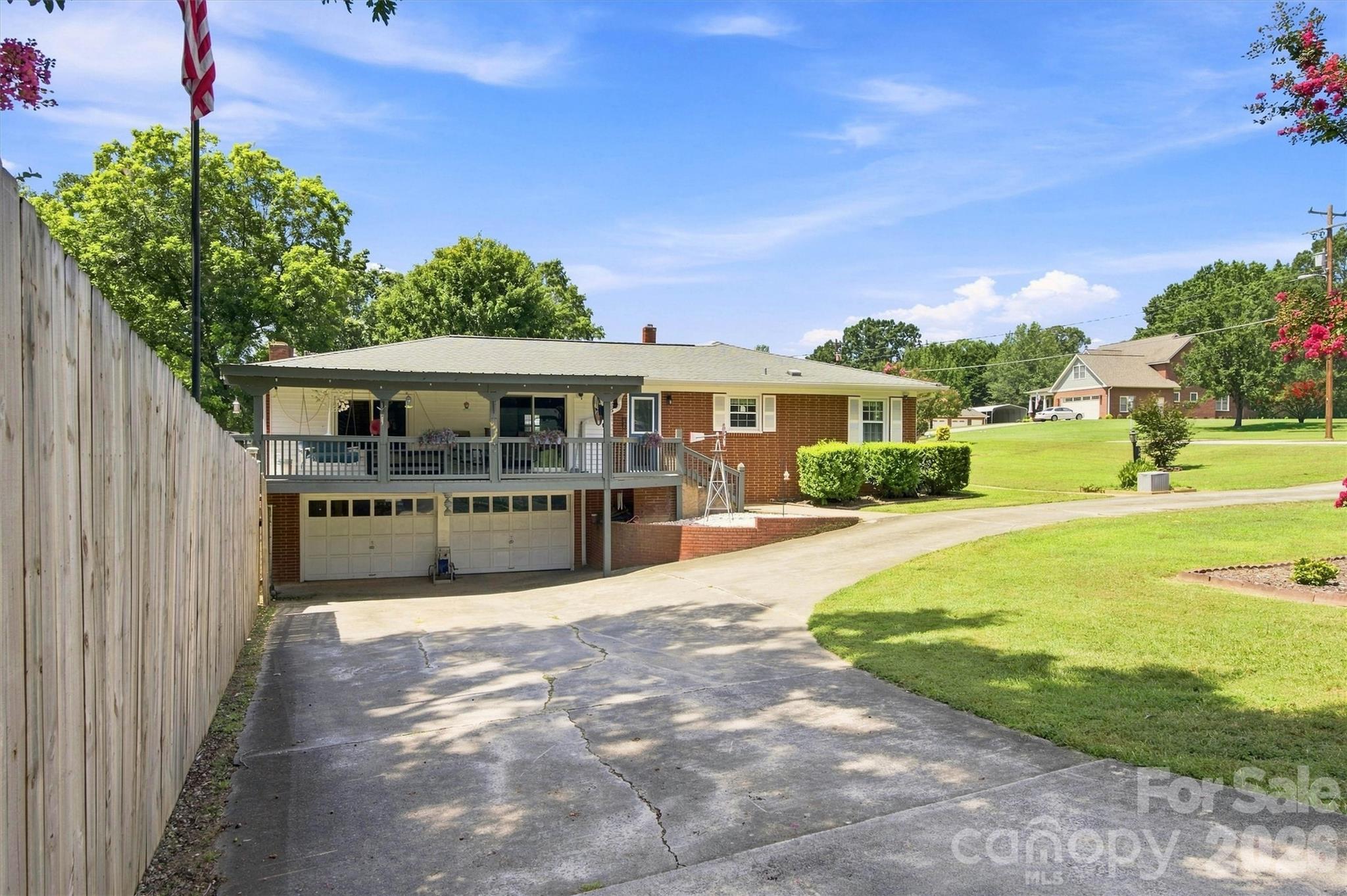 Covered deck, circular driveway and full two car garage with a heated and cooled basement workshop. - 148 Era Street, Troutman
