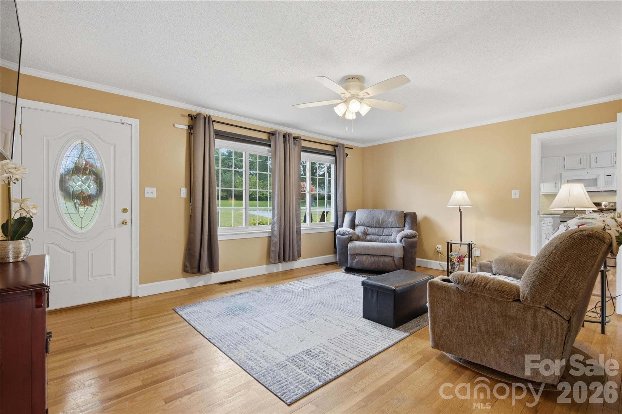 Spacious living room provides original hardwood flooring and plenty of sunshine. - 148 Era Street, Troutman