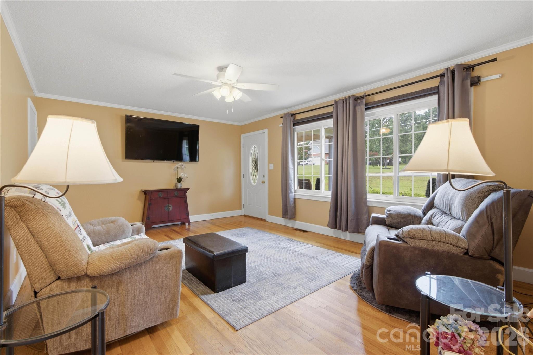 Spacious living room with original hardwood flooring. Plenty of natural sun light. - 148 Era Street, Troutman
