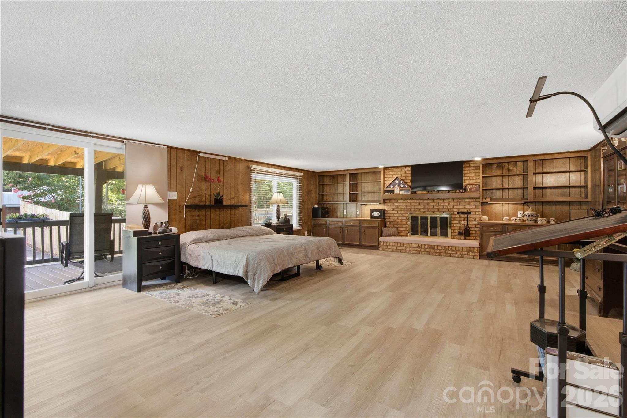 Huge primary bedroom/Den with gas fire place to enjoy the upcoming fall and winter seasons. Covered deck to step outside for some peace and quite time. - 148 Era Street, Troutman