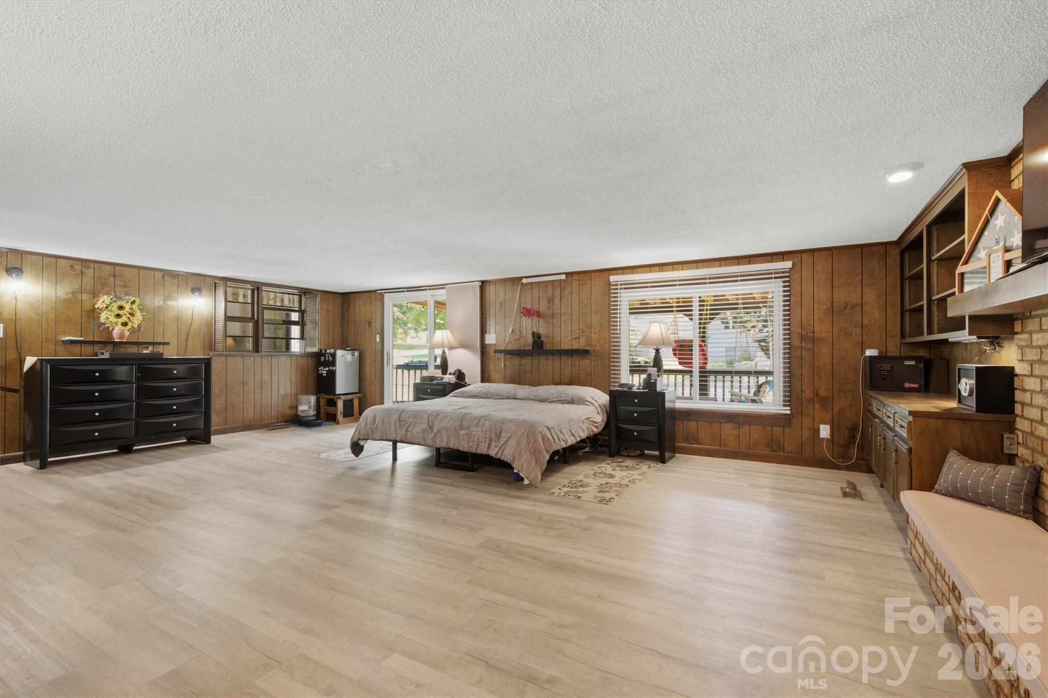 Primary bedroom/ Den has wonderful gas log fireplace, built in cabinets for plenty of storage. - 148 Era Street, Troutman