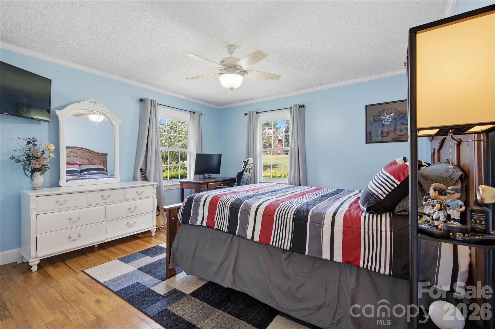 Bedroom two provides plenty of natural light and original hardwood flooring. - 148 Era Street, Troutman