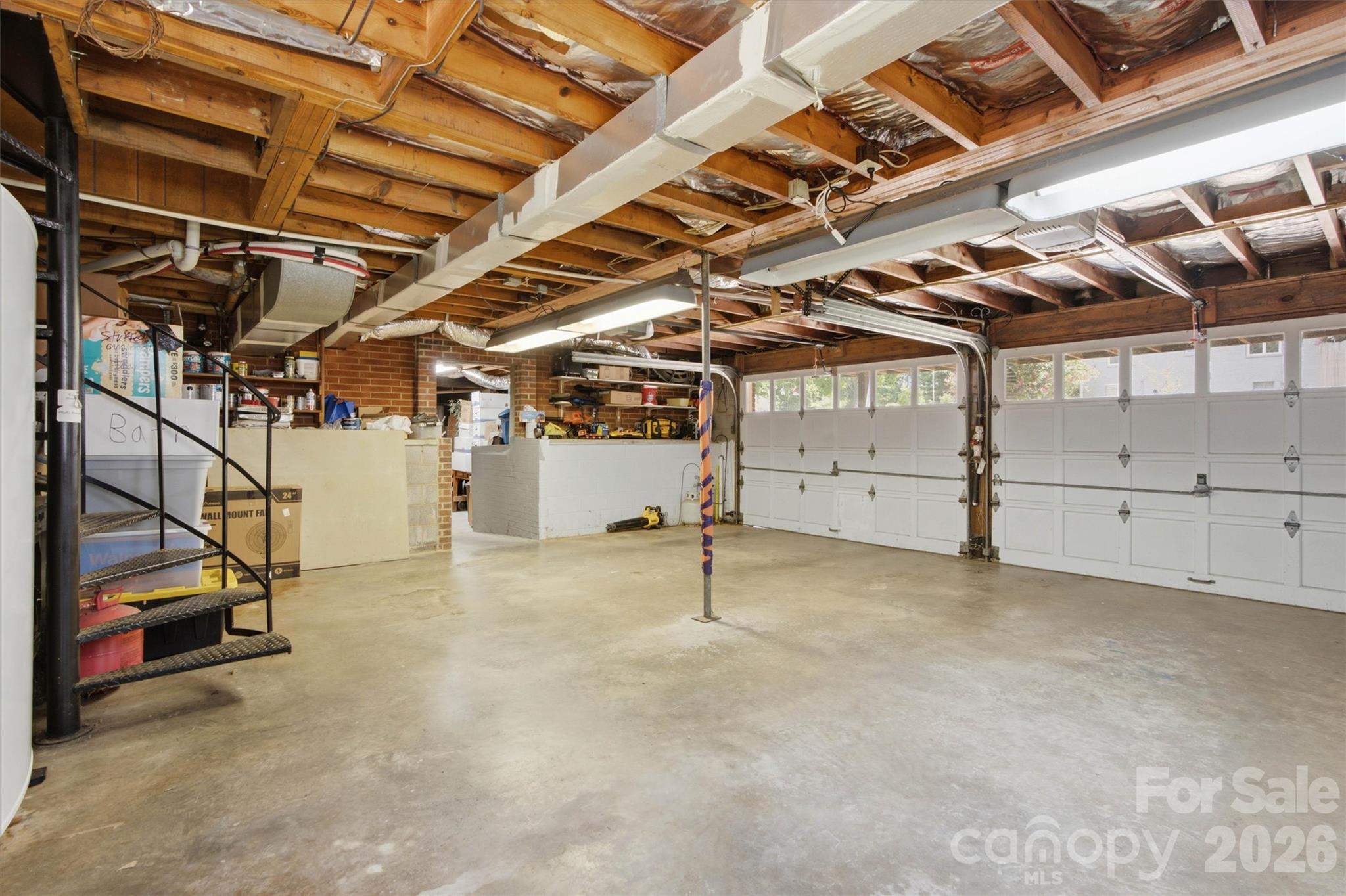 Huge two car garage with access stairs to the main level. Workshop is heated and cooled. - 148 Era Street, Troutman